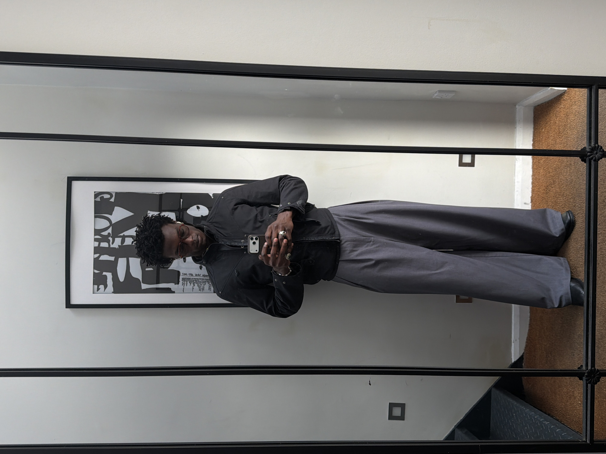 Man takes selfies near mirror and artwork in London