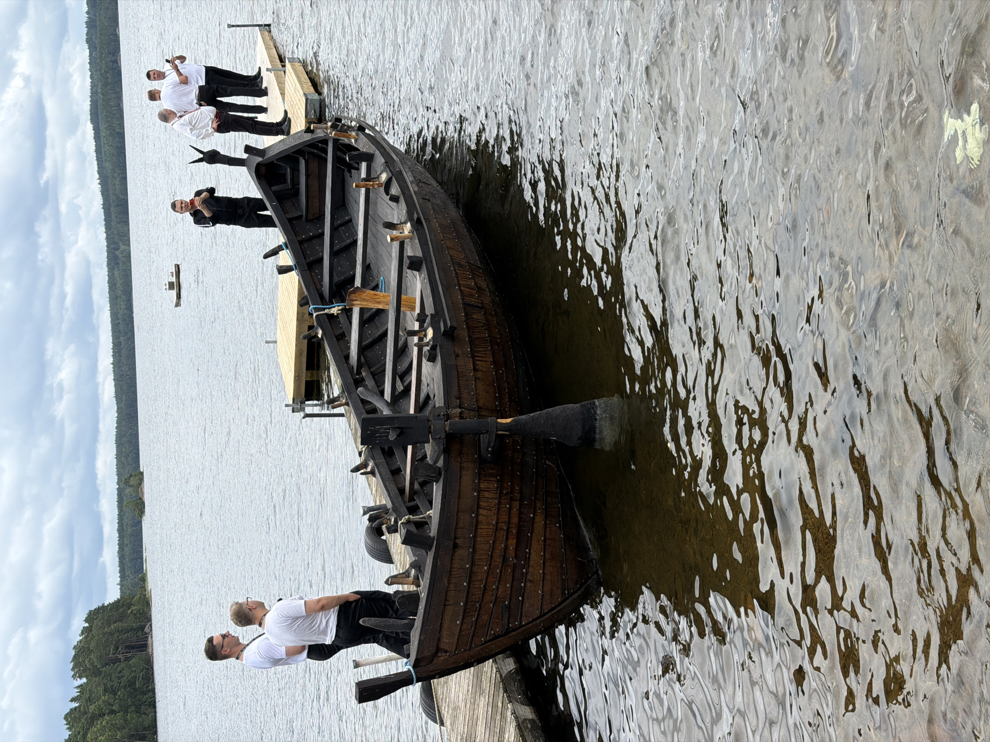 Swedish lakeside camp with Viking boat, gardens, and brass instrument