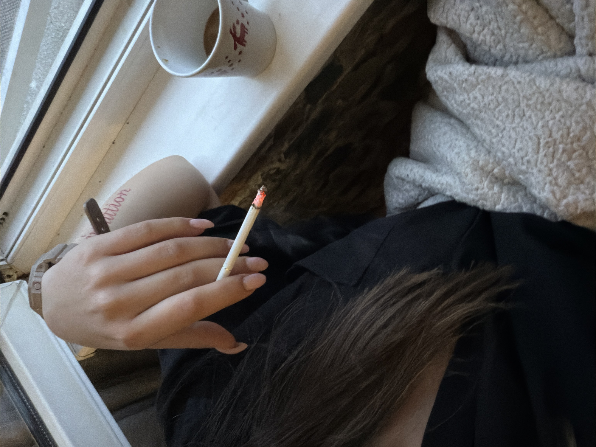 Early morning coffee and cigarette by window in Sofia