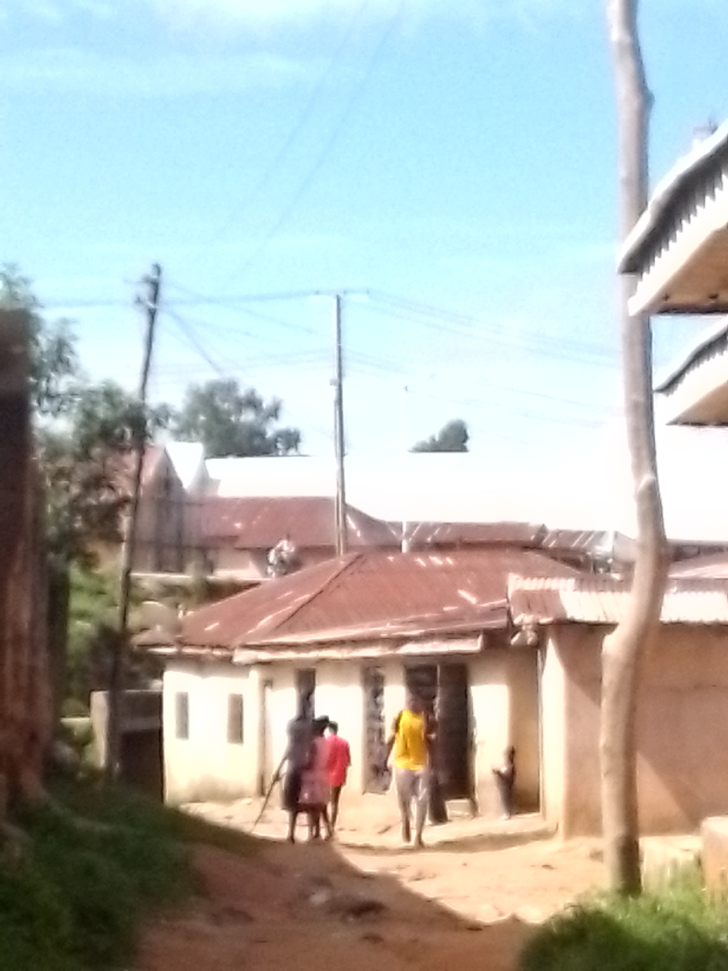 Foot traffic along dusty alleyways in a modest urban neighborhood