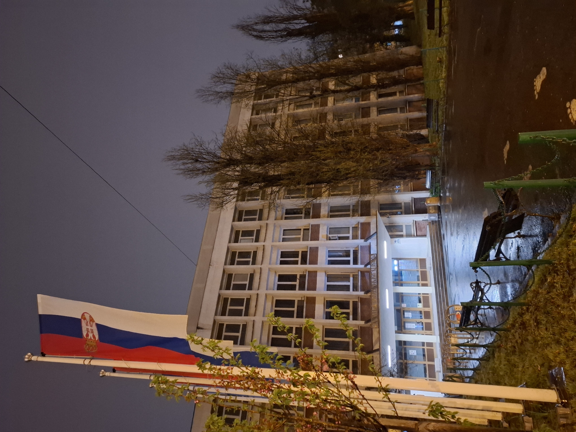 Serbian flag waves at dusk in Novi Sad