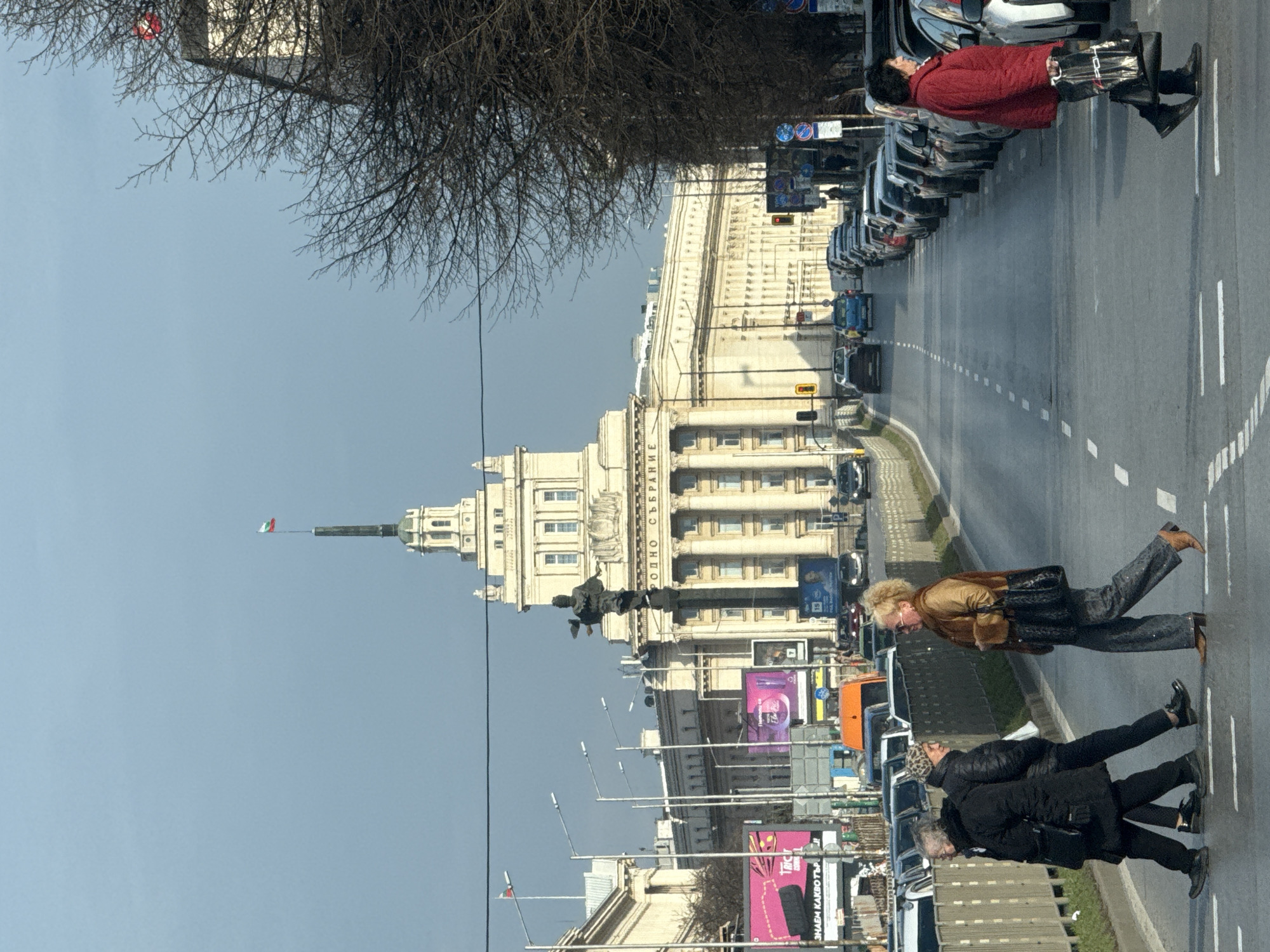 Sofia street traffic and pedestrians near classical government building