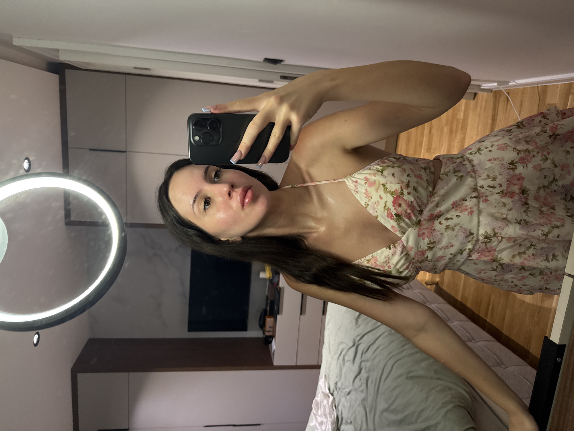 Mirror selfies in a floral dress, bedroom setting