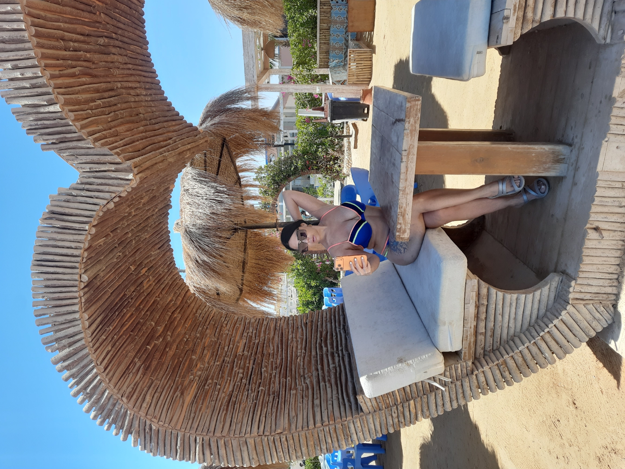 Woman relaxes in wooden shelter structure in Hurghada