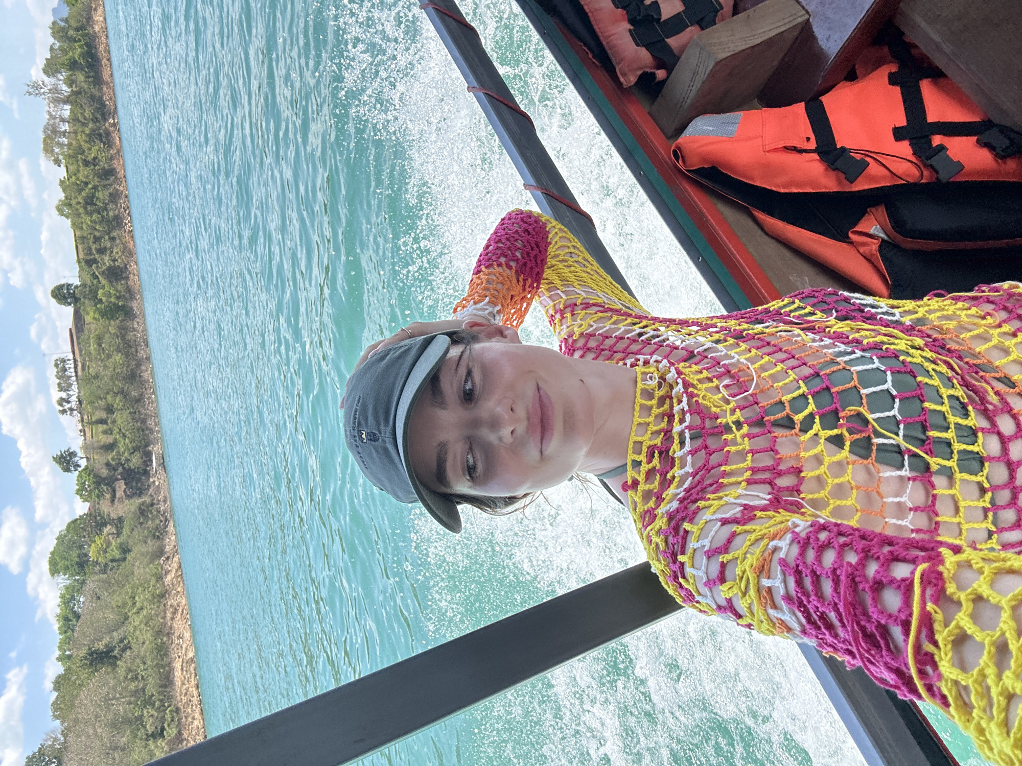 Woman travels by boat through turquoise waters in Thailand