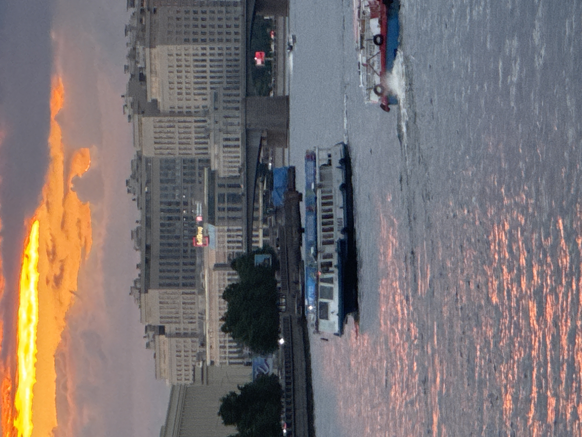 Sunset boat traffic and city streets along Saint Petersburg's Neva River