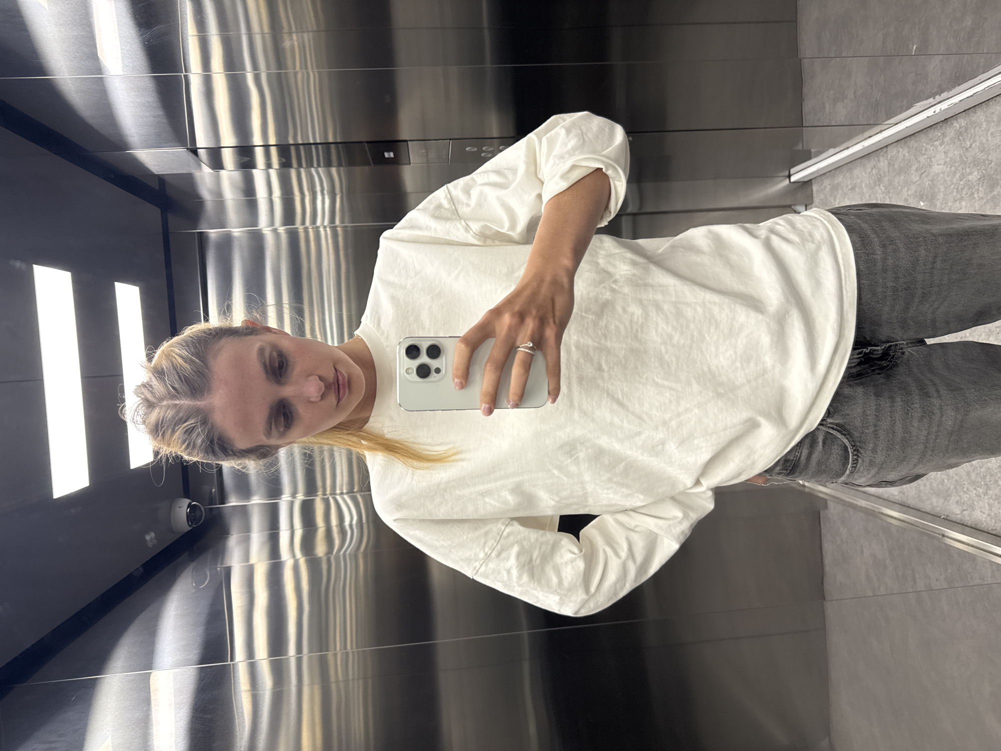 Woman Takes Selfie in Stainless Steel Elevator