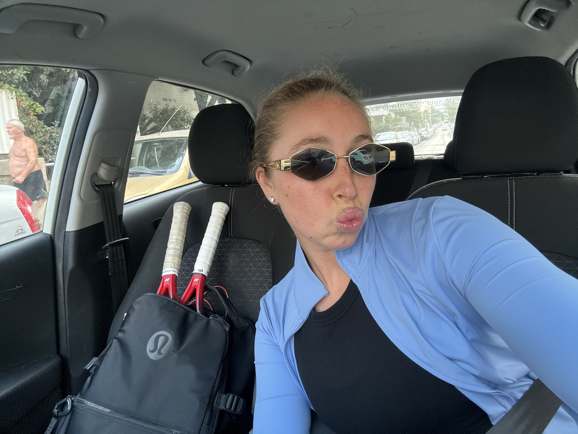 Driver's seat selfie, Tel Aviv streets in the background
