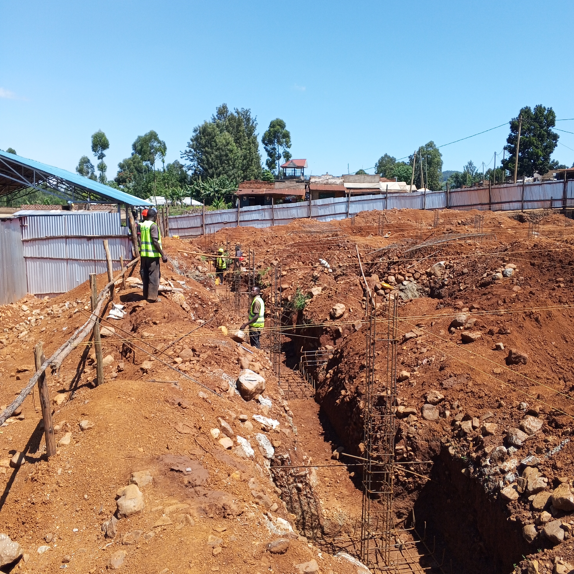 Construction workers build foundations in Borabu Chitago ward