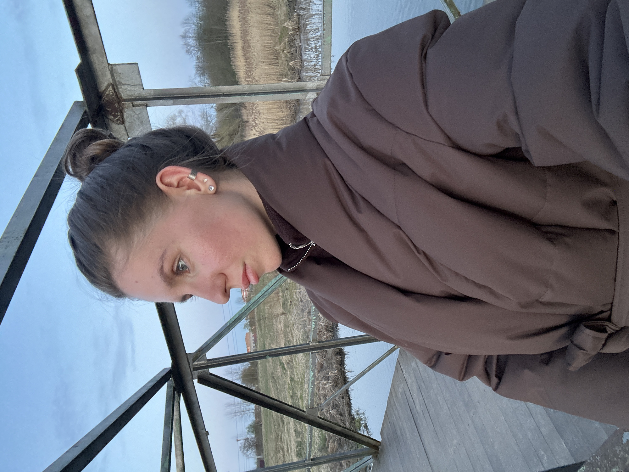 Couple films evening walk along waterfront in Klin, Russia