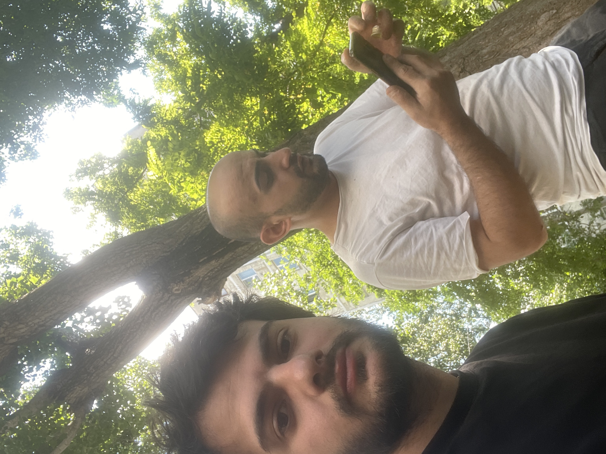 Two men hang out in downtown Tbilisi park area