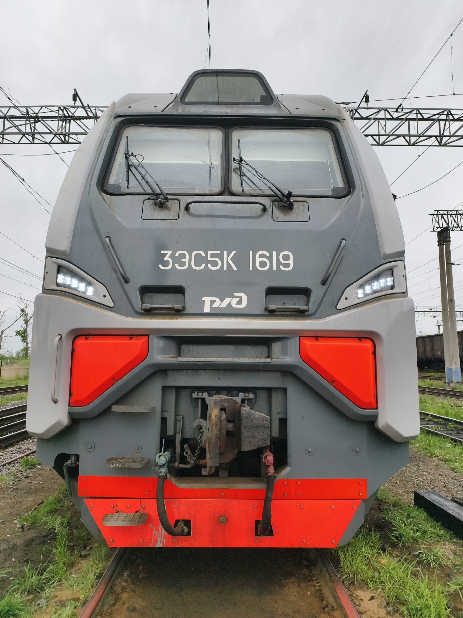 Rail worker documents train journey across metal bridge