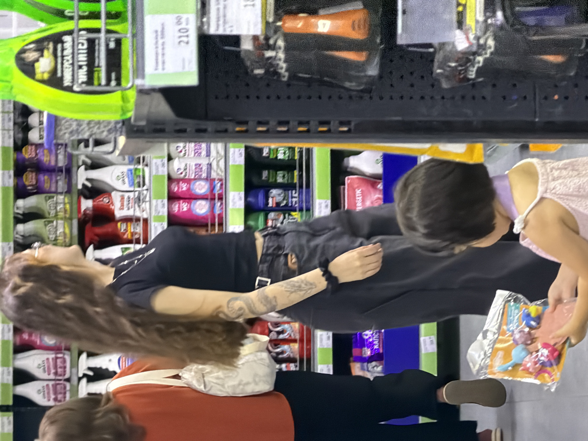 Shoppers browse aisles of a busy retail store
