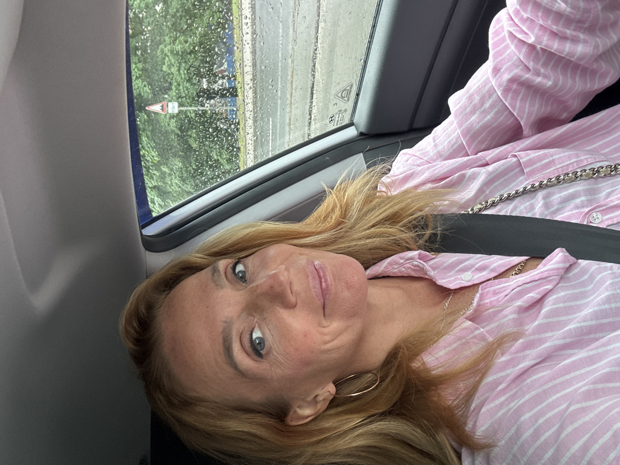 Smiling from the driver's seat on a rainy Saint Petersburg day