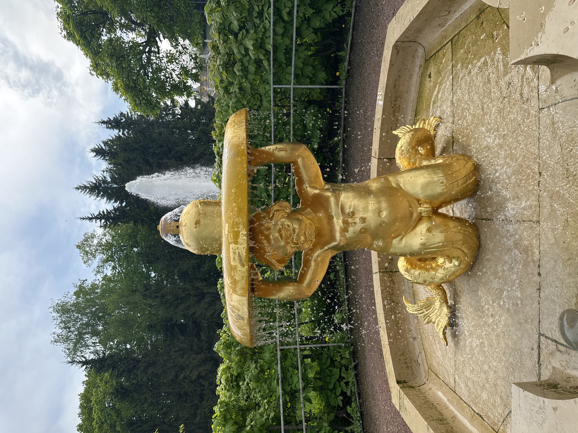 Tourist documents fountains and gardens at Peterhof Palace, Russia