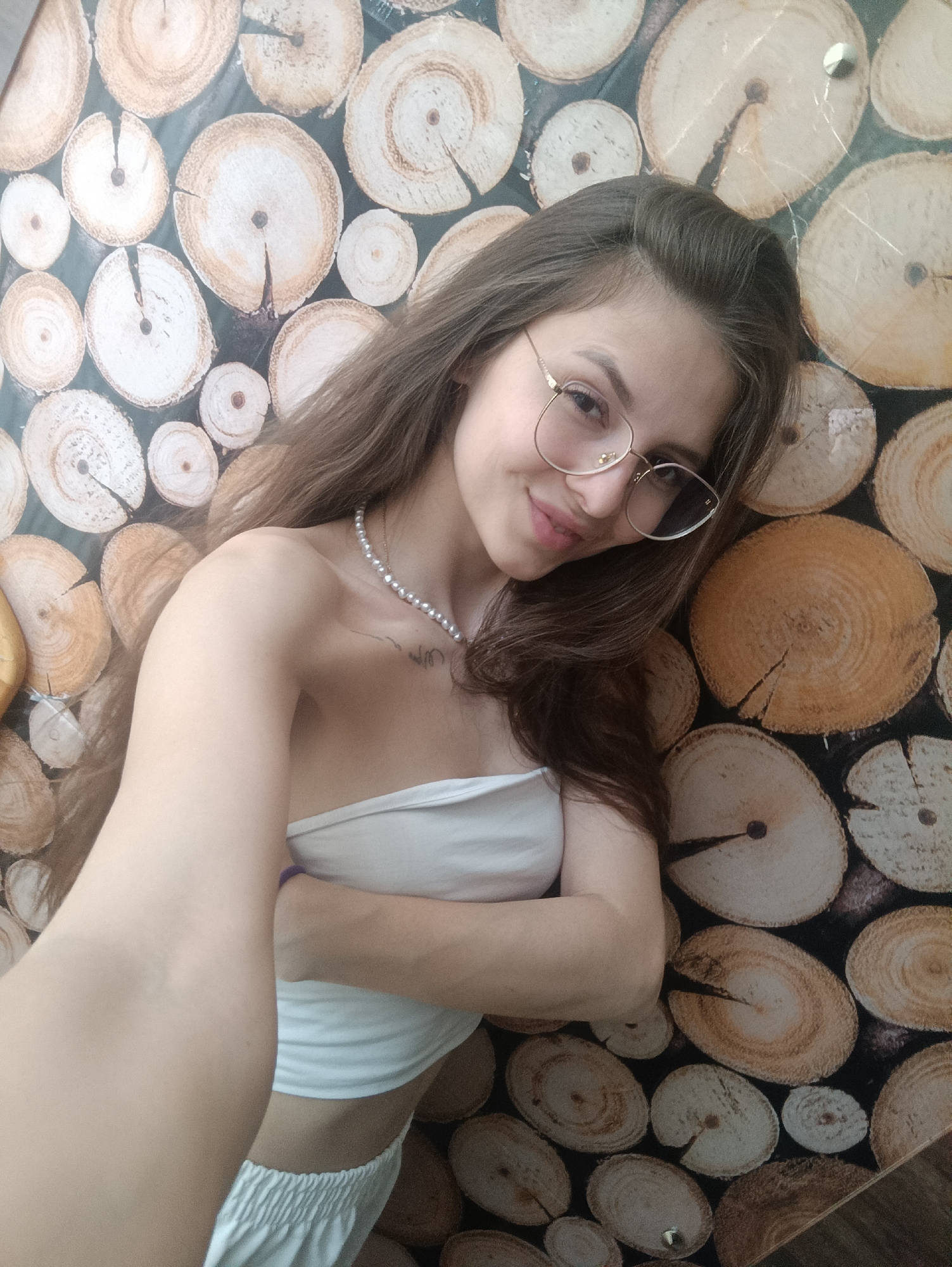 Woman documents morning selfie session indoors