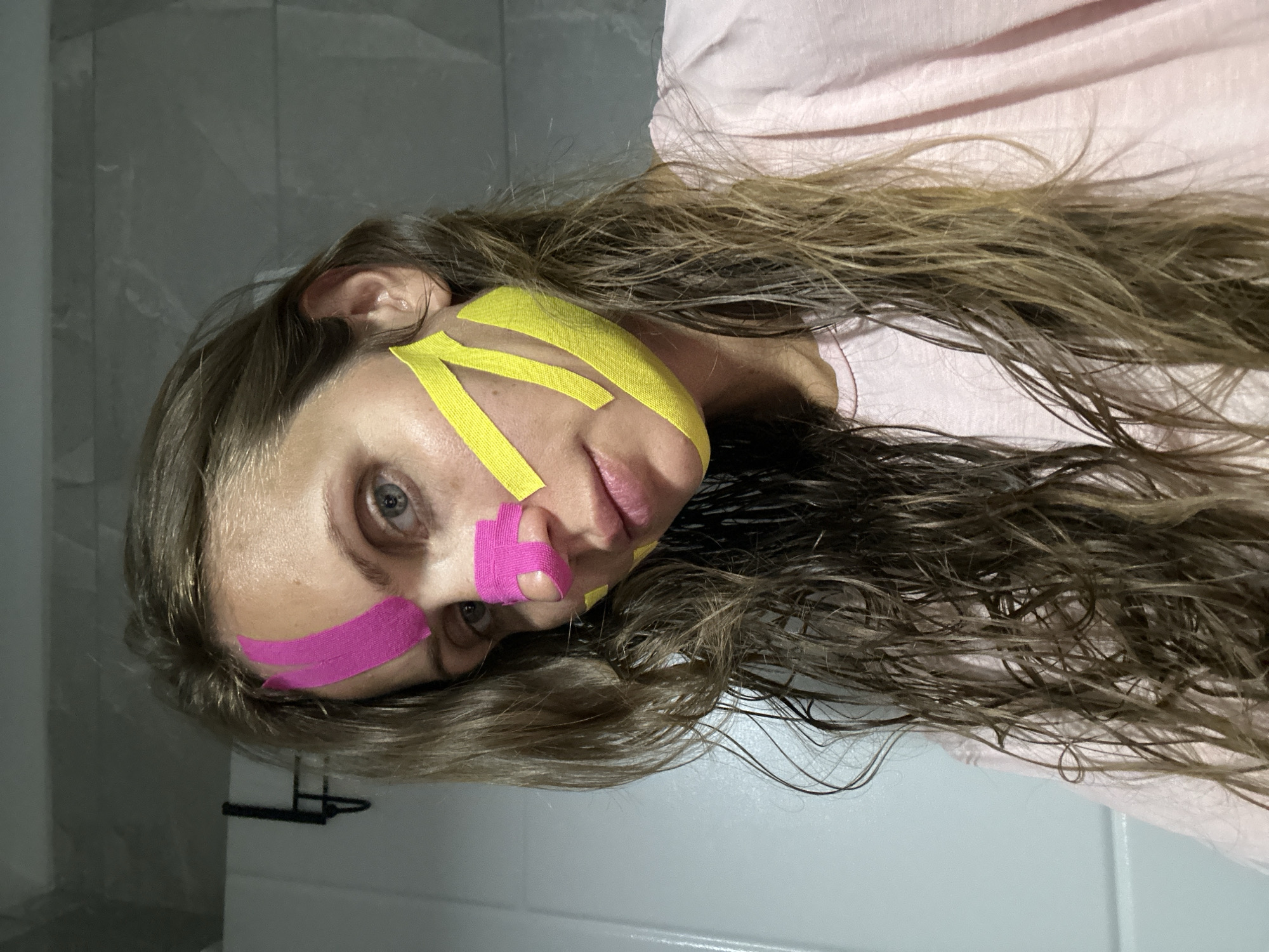 Woman applies beauty treatment in Fethiye bathroom