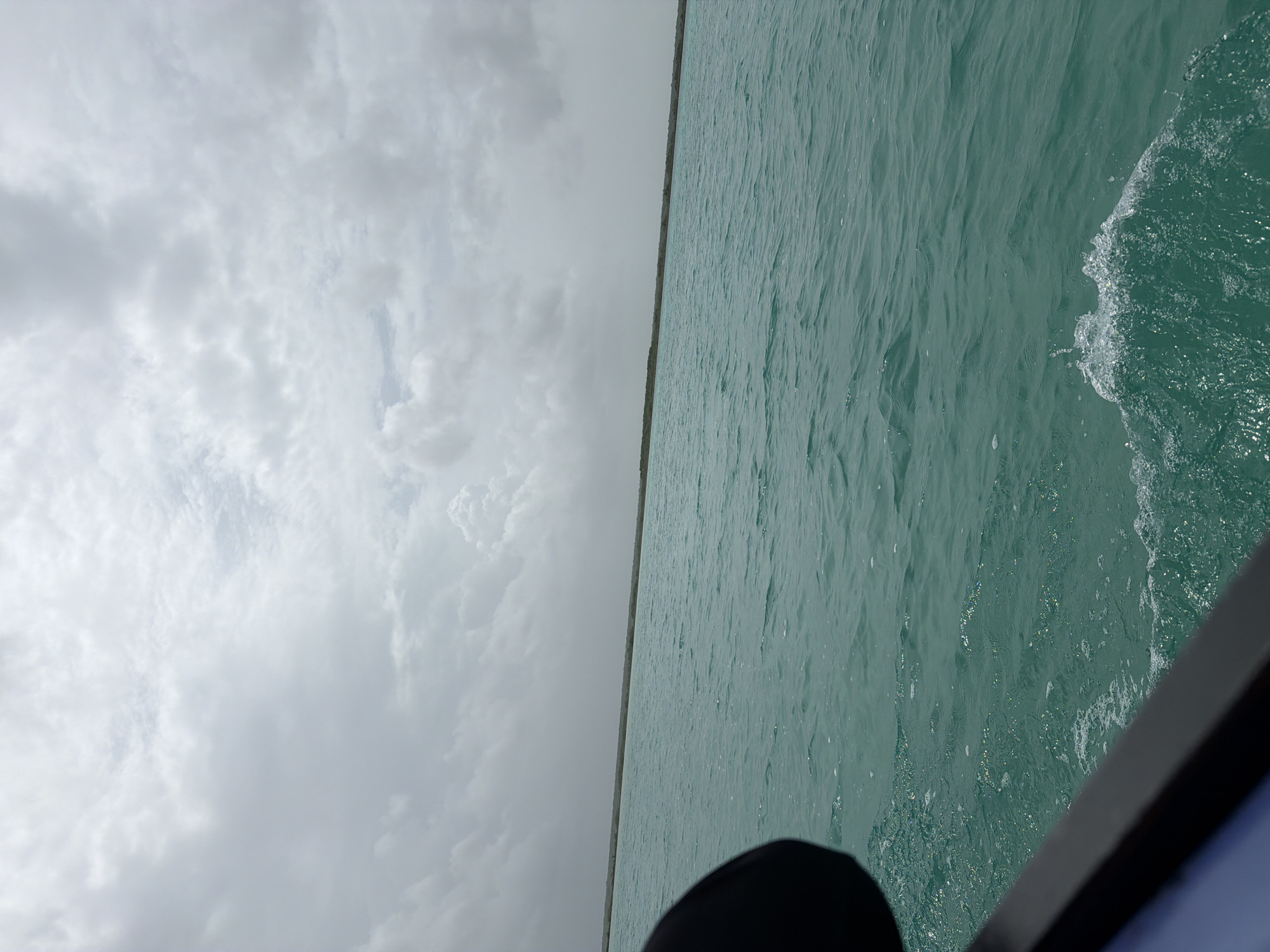 Sailing Bacalar Lagoon's turquoise waters on an overcast afternoon