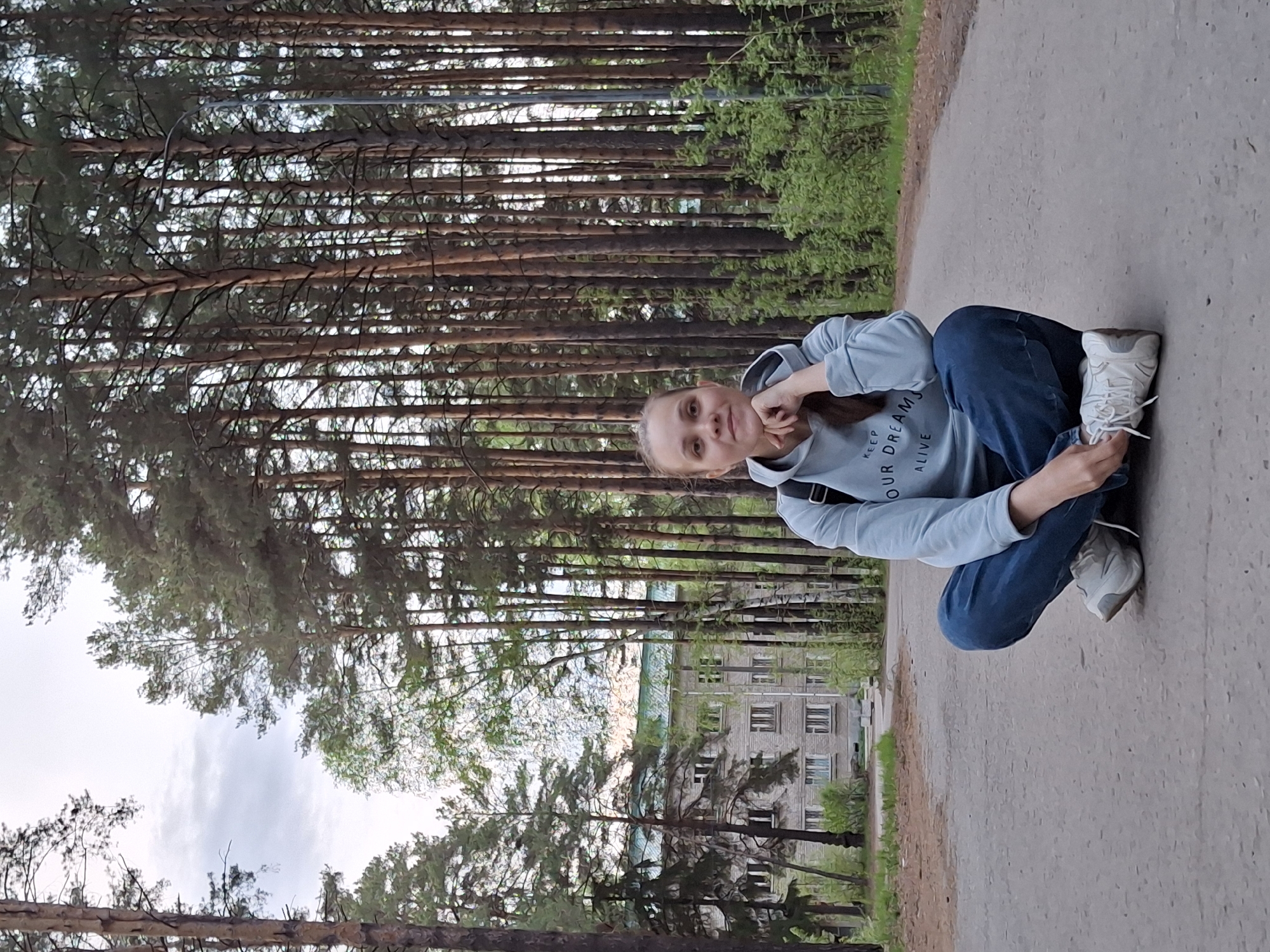 Woman walks forest paths near Chaikovsky, Russia Wednesday afternoon