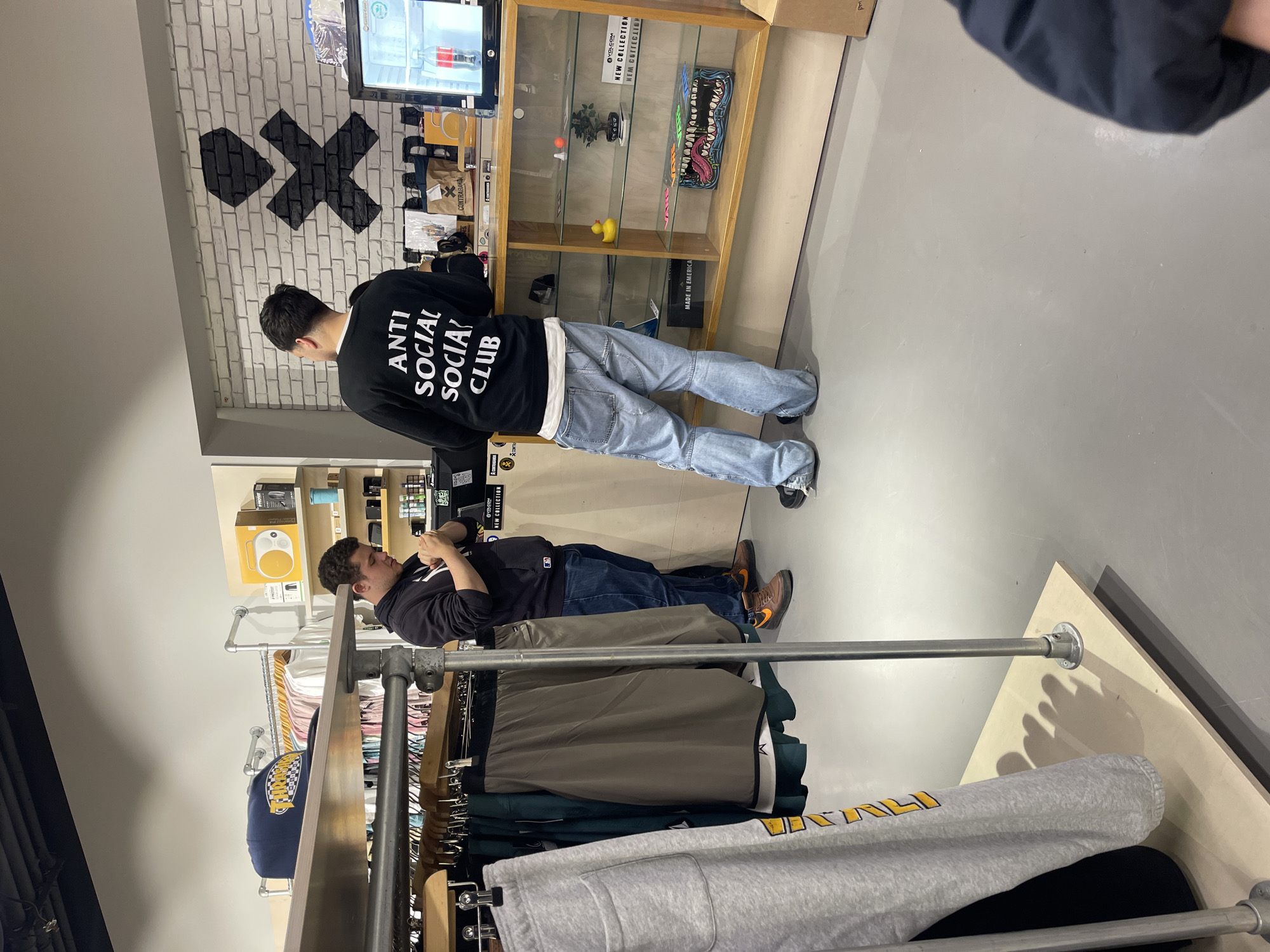 Shoppers browse clothing store and eat in Sofia
