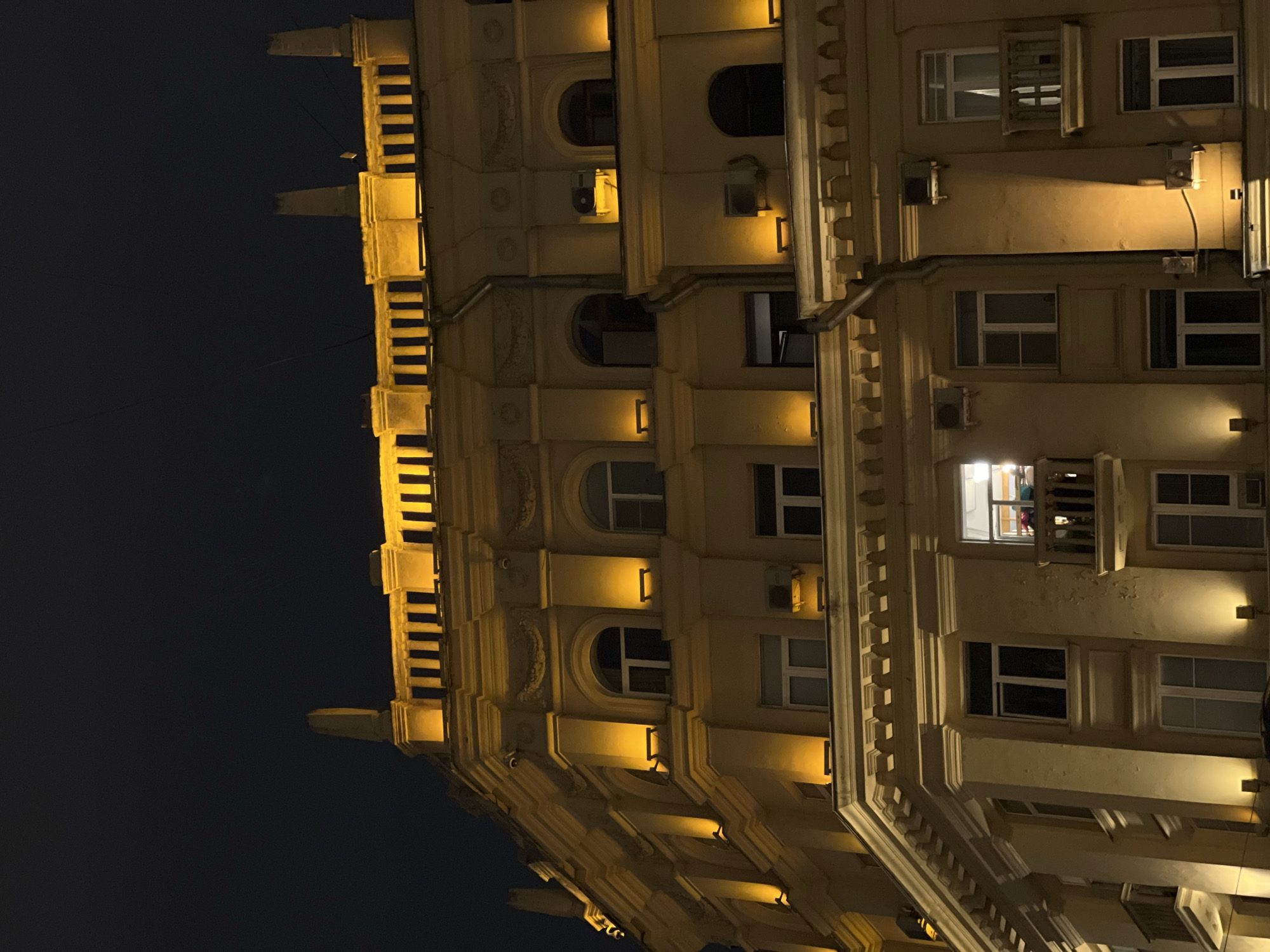 Nighttime architectural photography session captures illuminated Moscow building facade