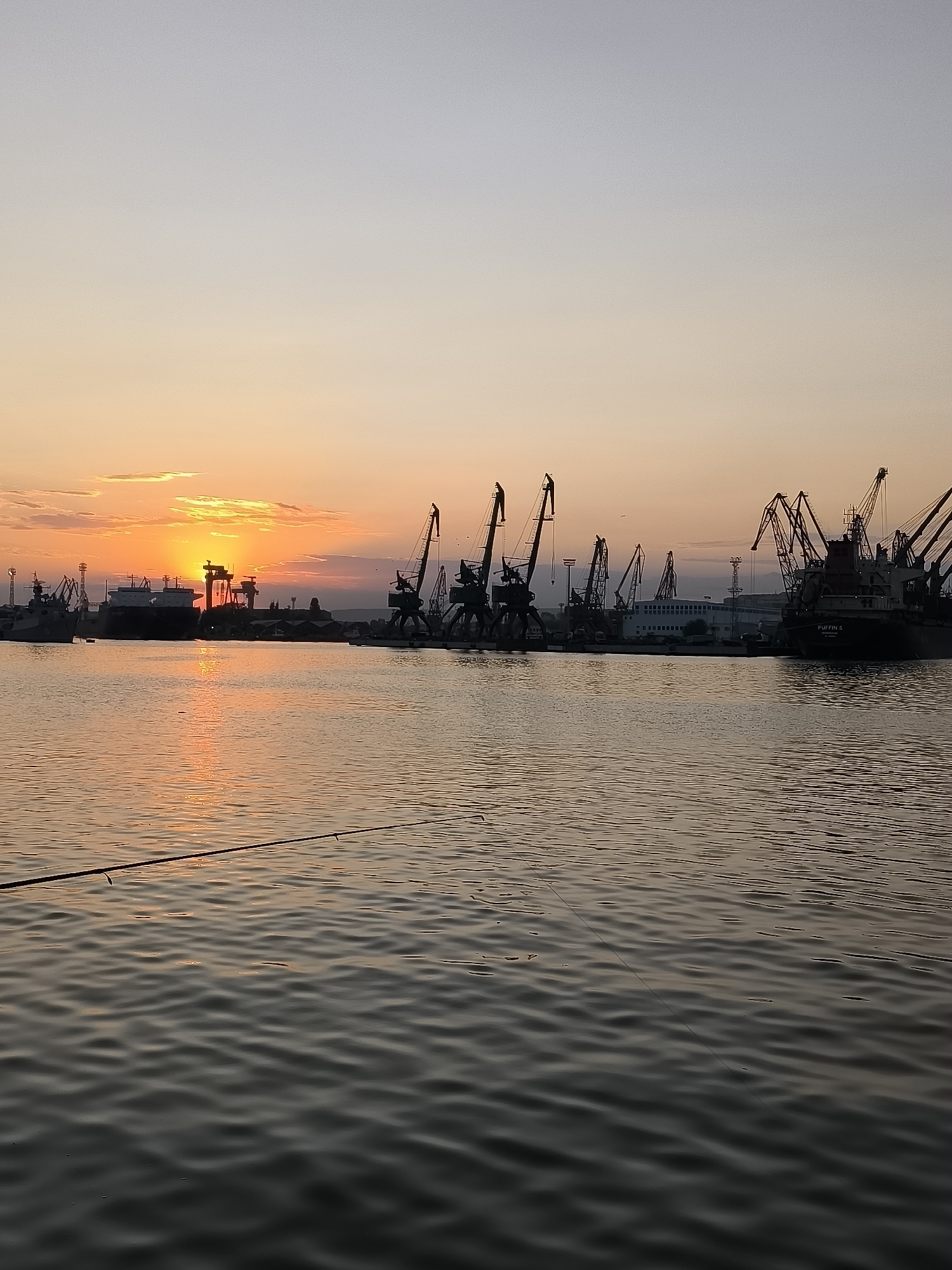 Golden sunset fades over Varna's port skyline