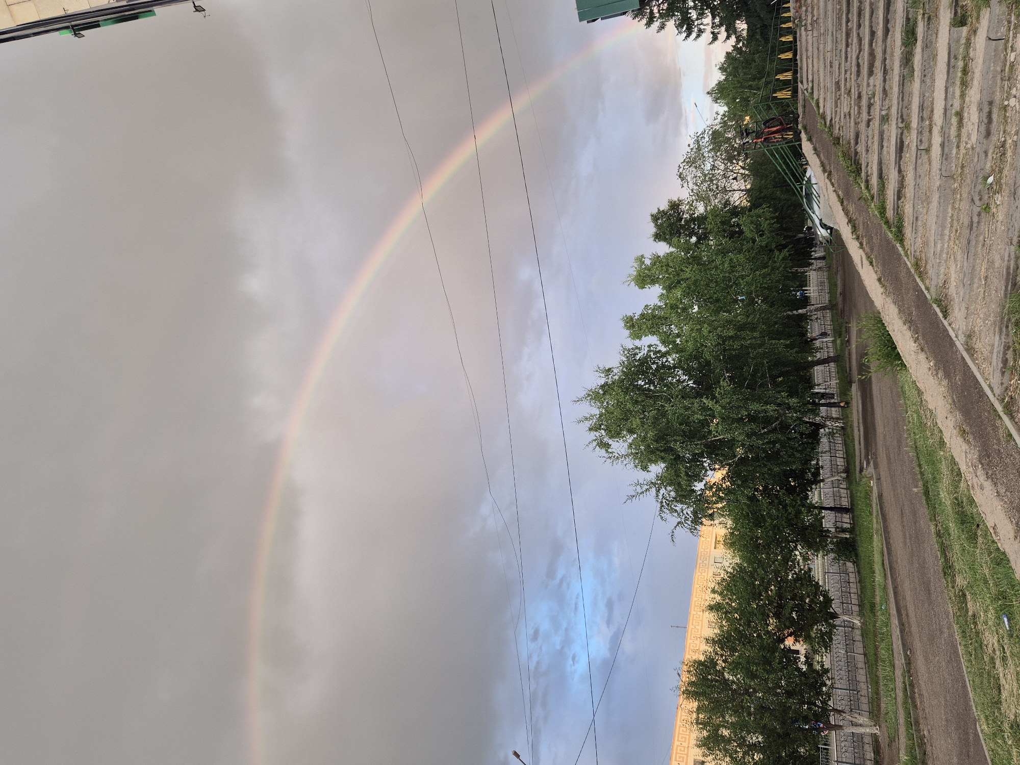 Double rainbow arcs over Kokshetau, Kazakhstan cityscape and mosque