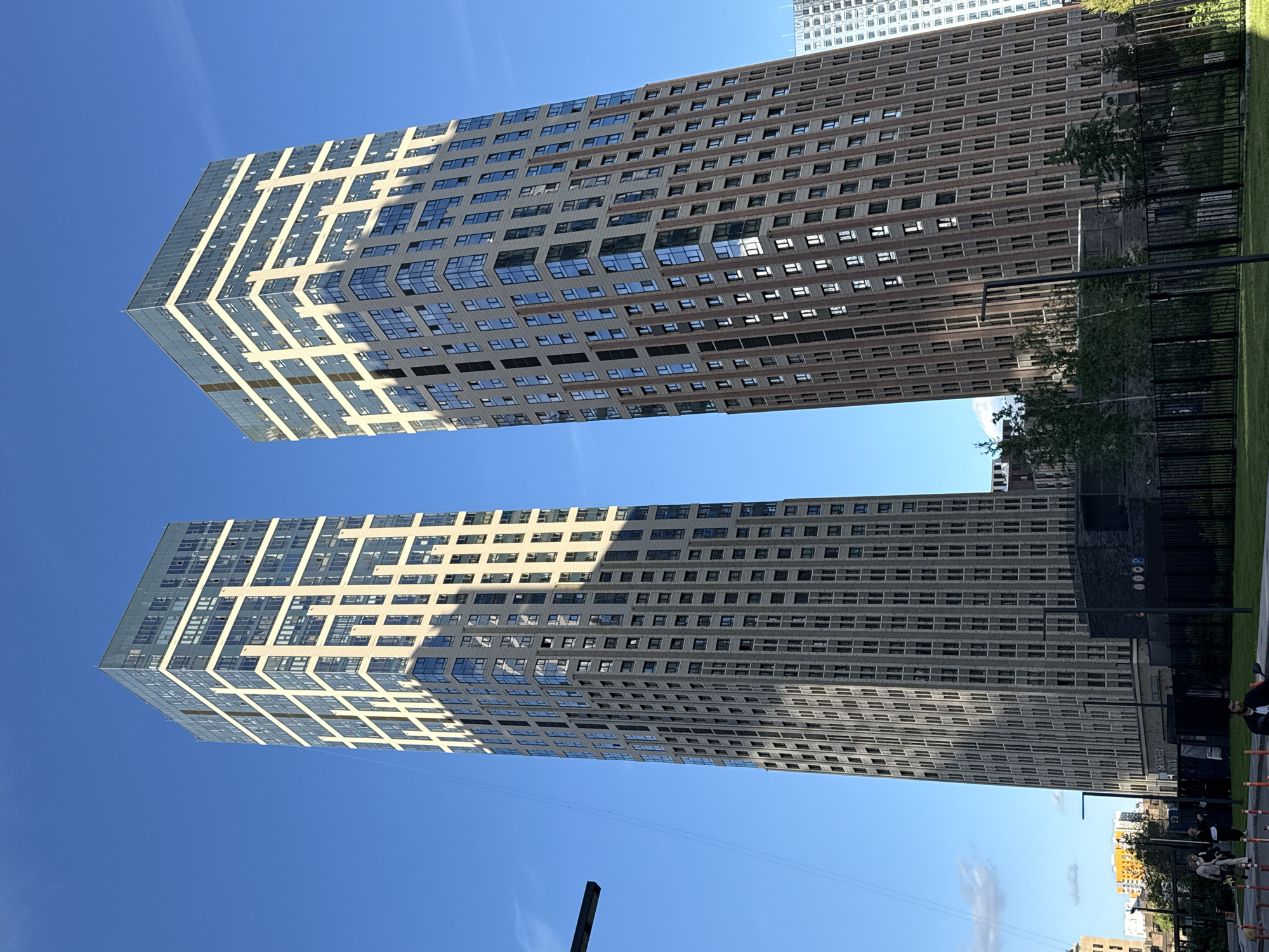 Twin skyscrapers and a dog walk in an urban scene