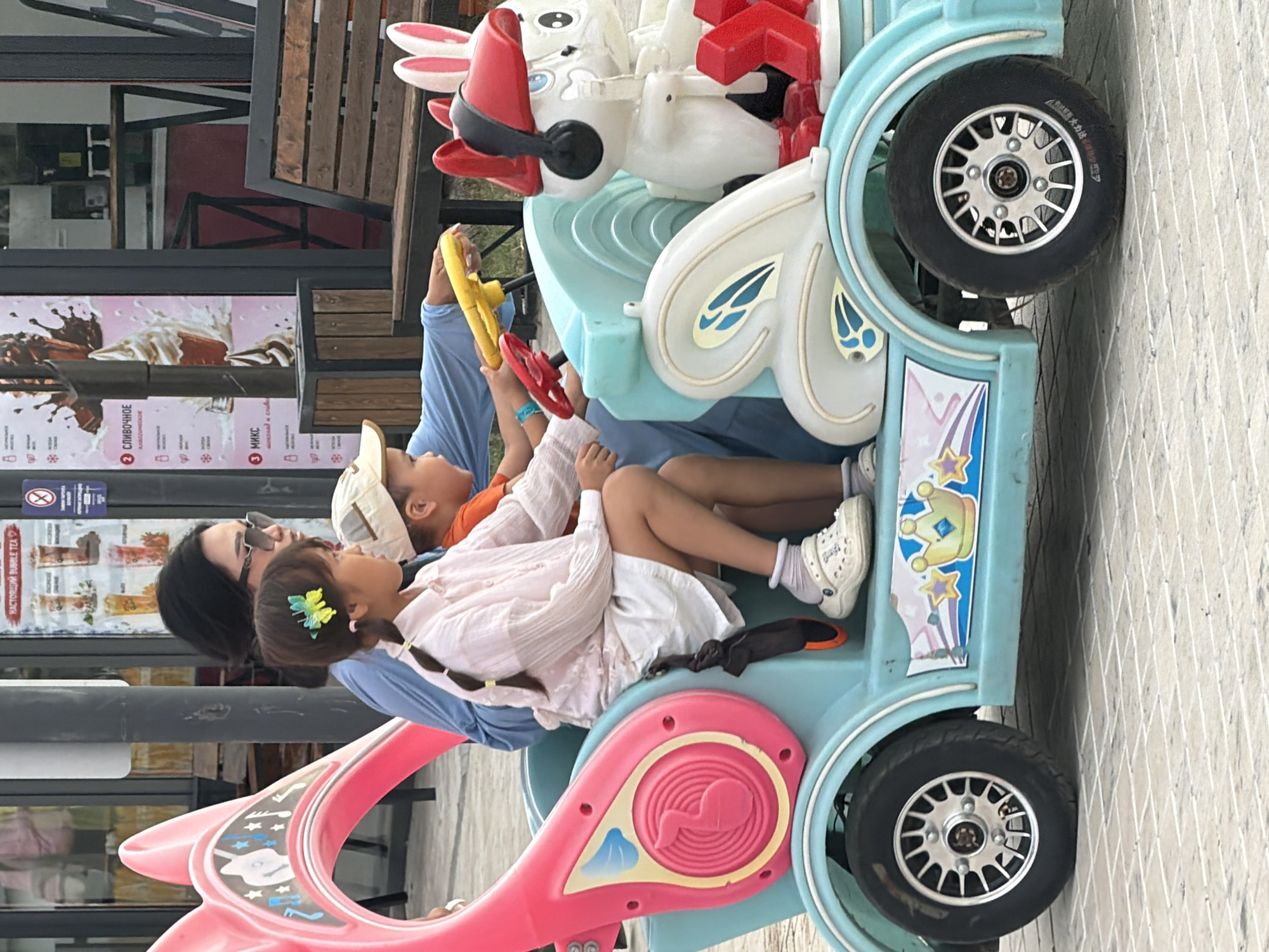 A busy outdoor amusement park on a late afternoon visit