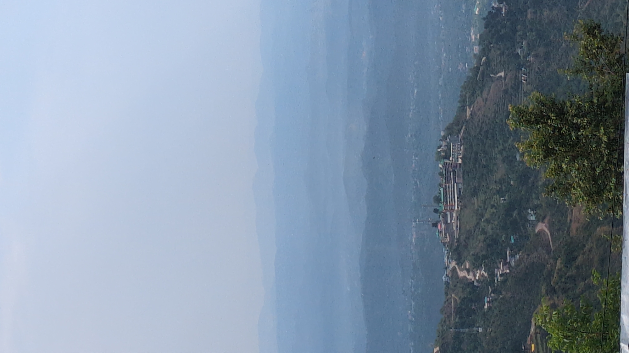 Man pulls rope in mountainous Haini, India before dawn