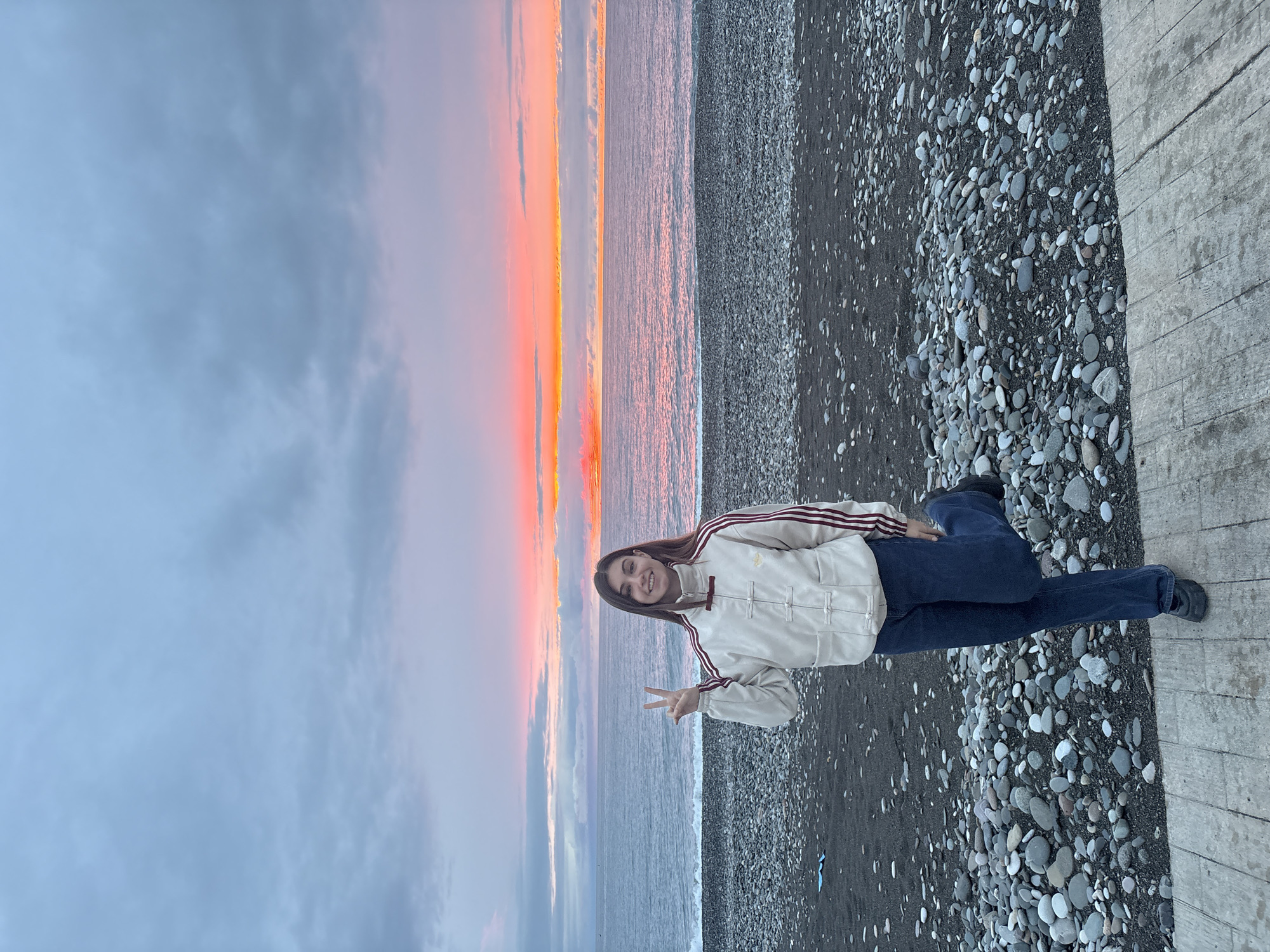 Woman photographed at sunset beach in Batumi, Georgia