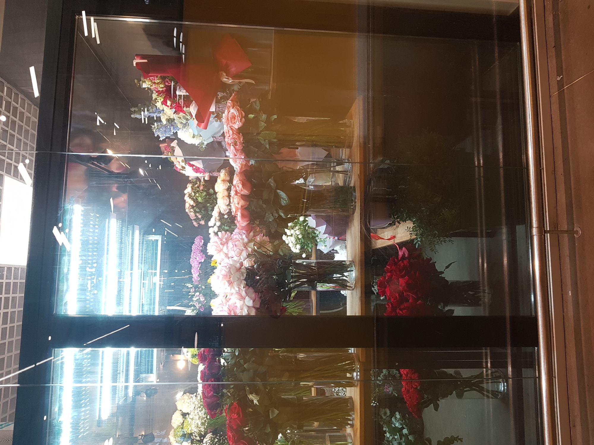 Flower arrangements observed in refrigerated display case in Saint Petersburg