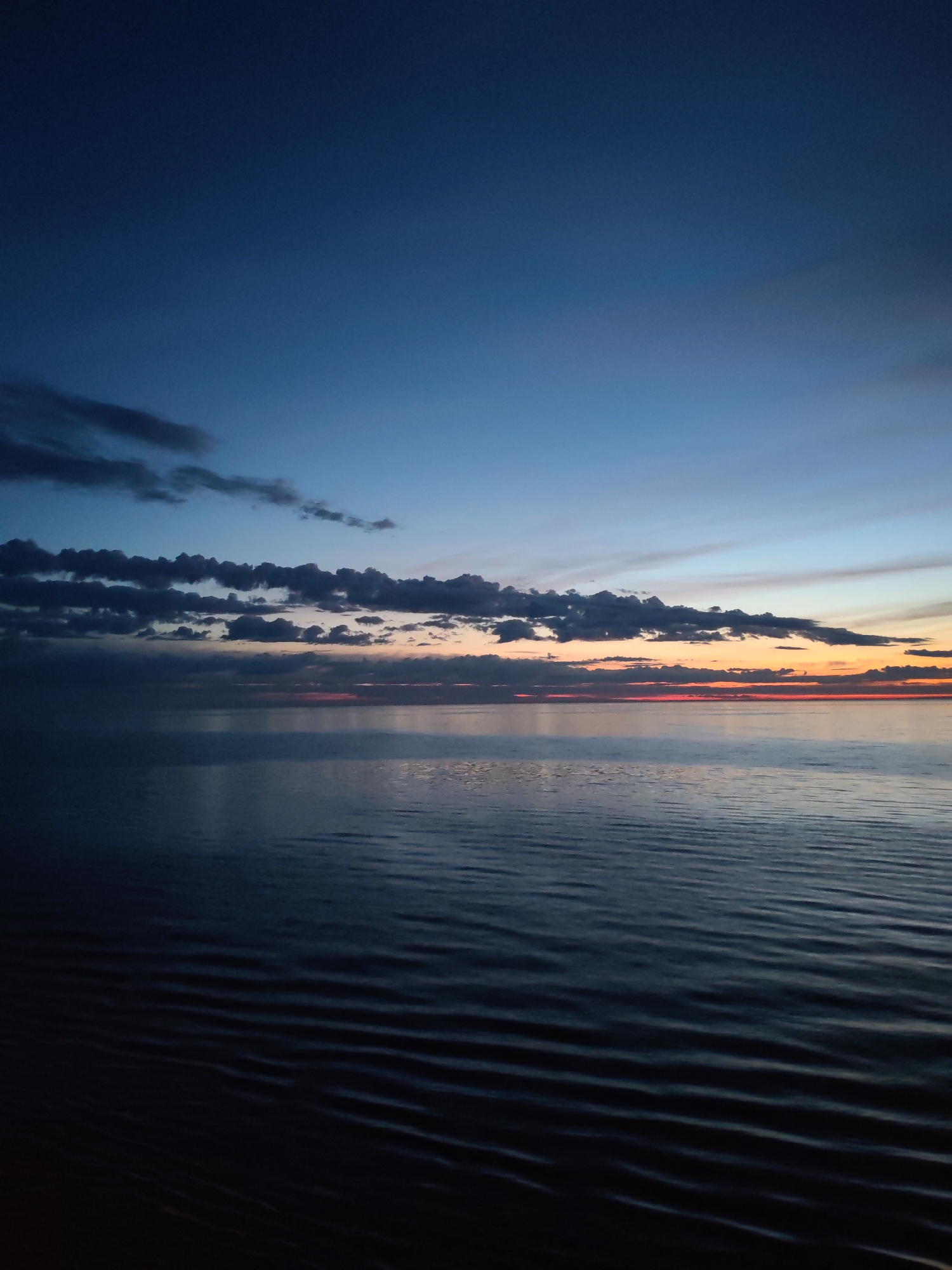 Twilight observed over calm waters at sea