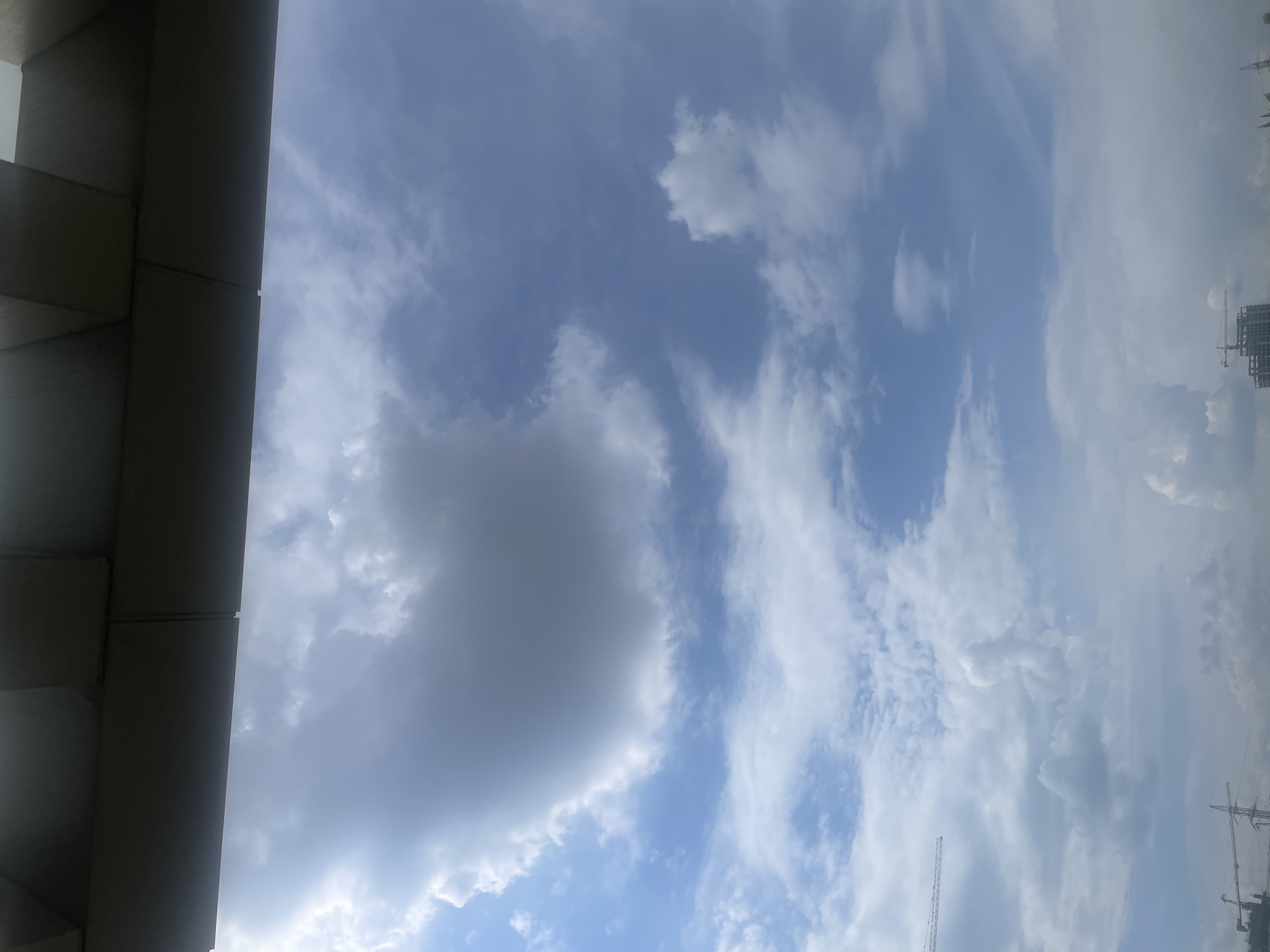 Construction activity documented across Yerevan skyline under partly cloudy skies
