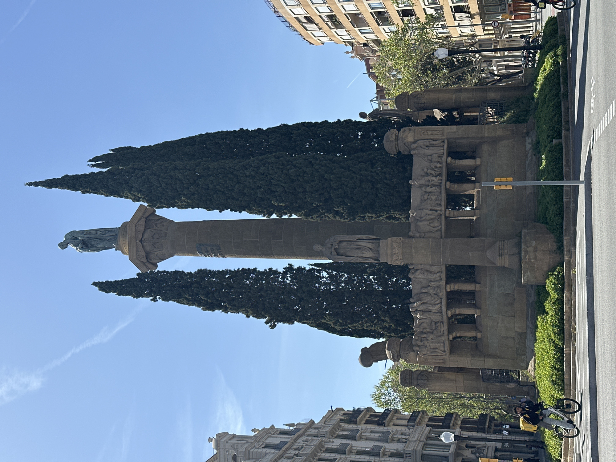 Columbus Monument documented in Barcelona with cypress trees