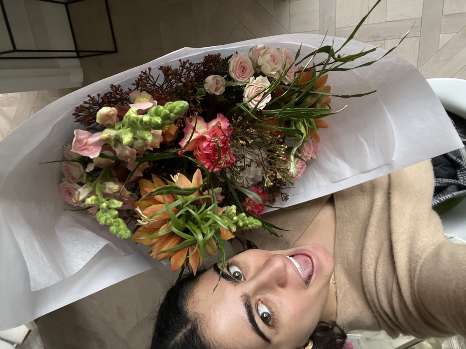 Woman photographed with vibrant flower bouquet in Paris