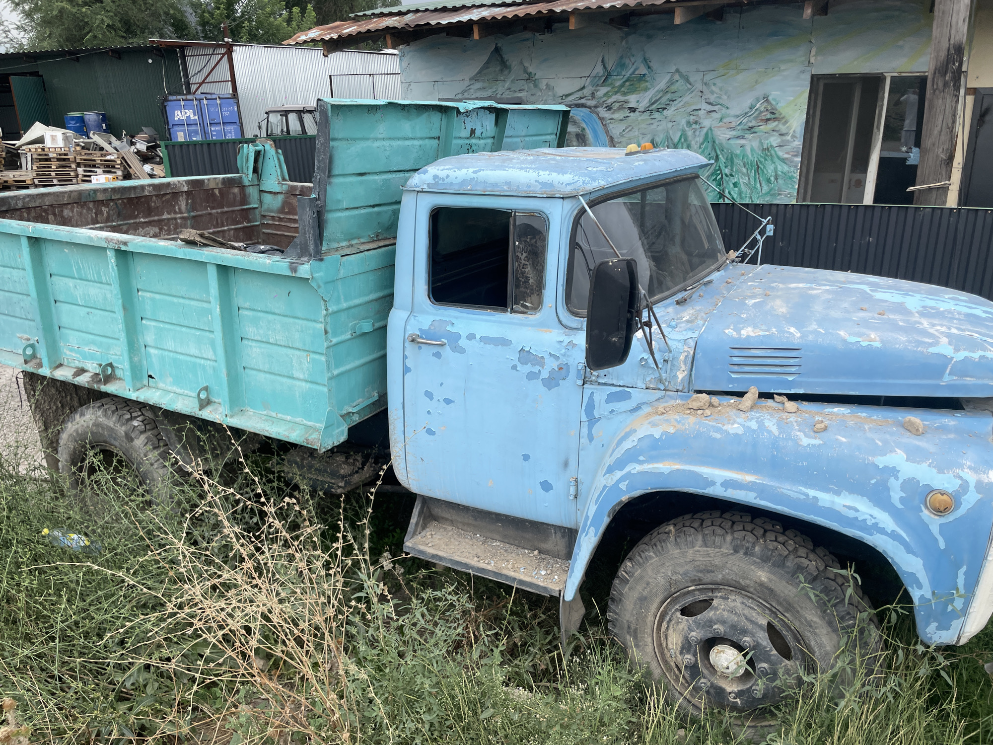 Quiet Kazakh village morning mixing rust, scrubland, and industry
