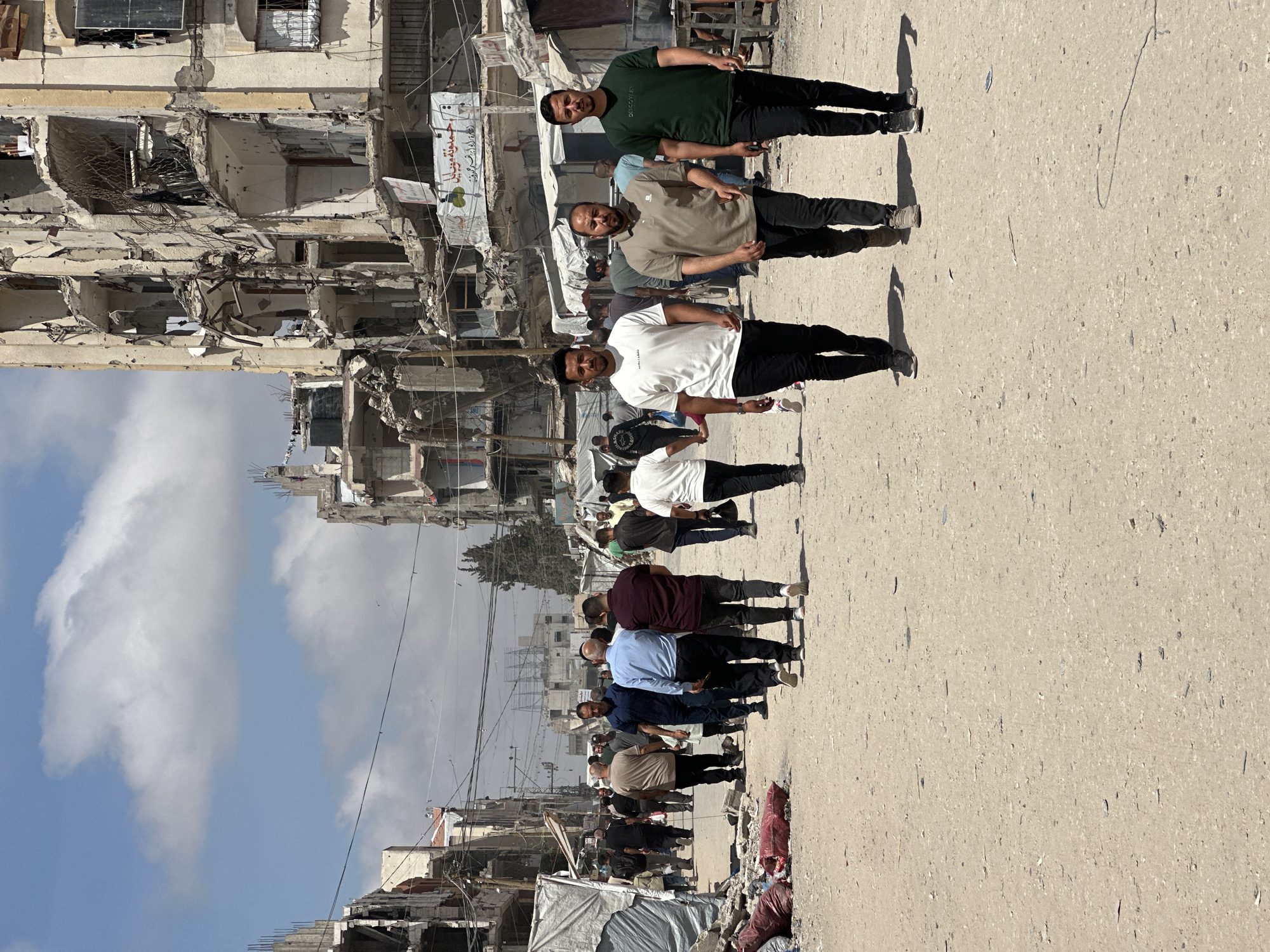 Men walk through war-damaged Gaza City street