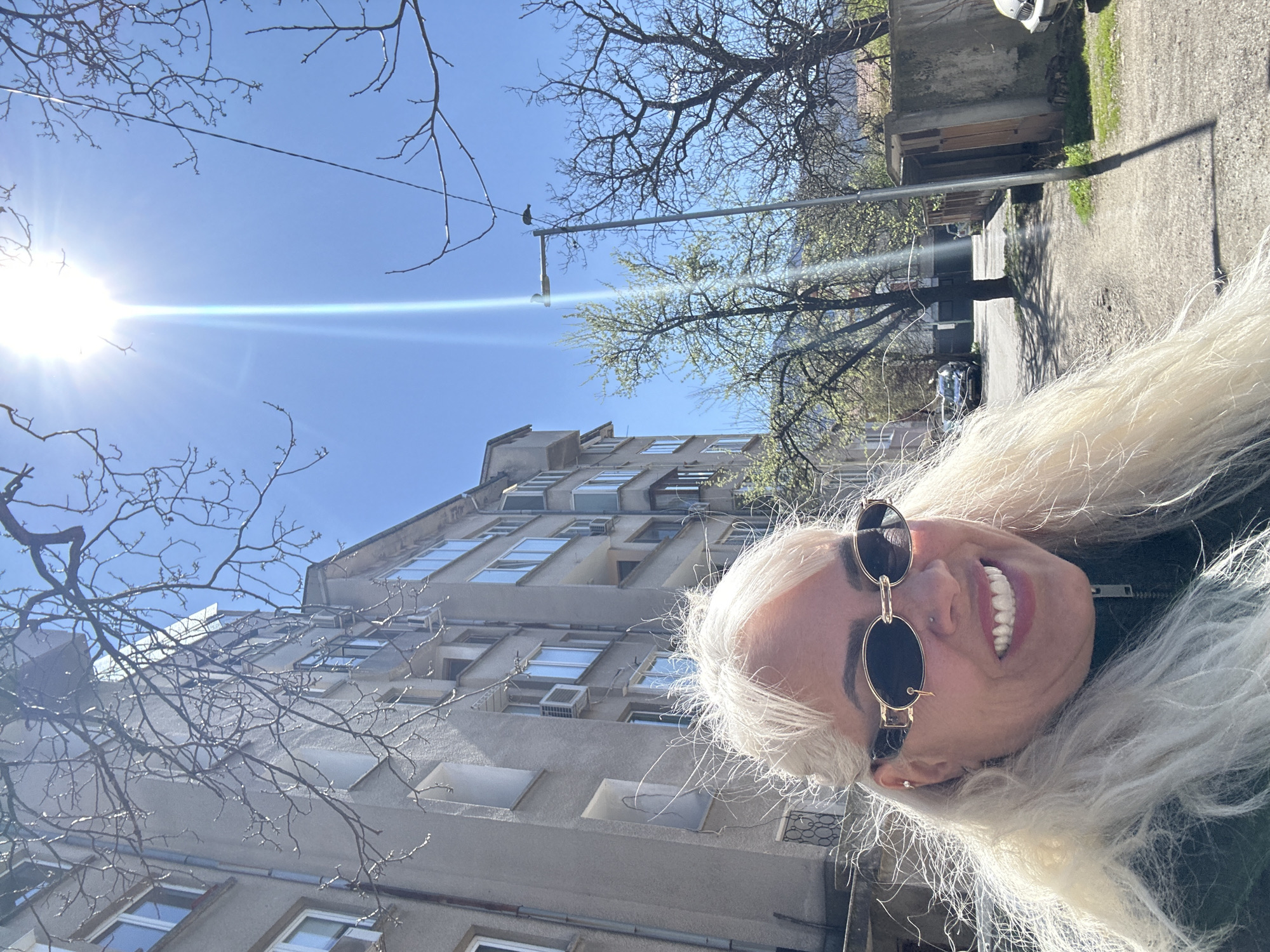 Woman photographed smiling outside residential building in Sofia