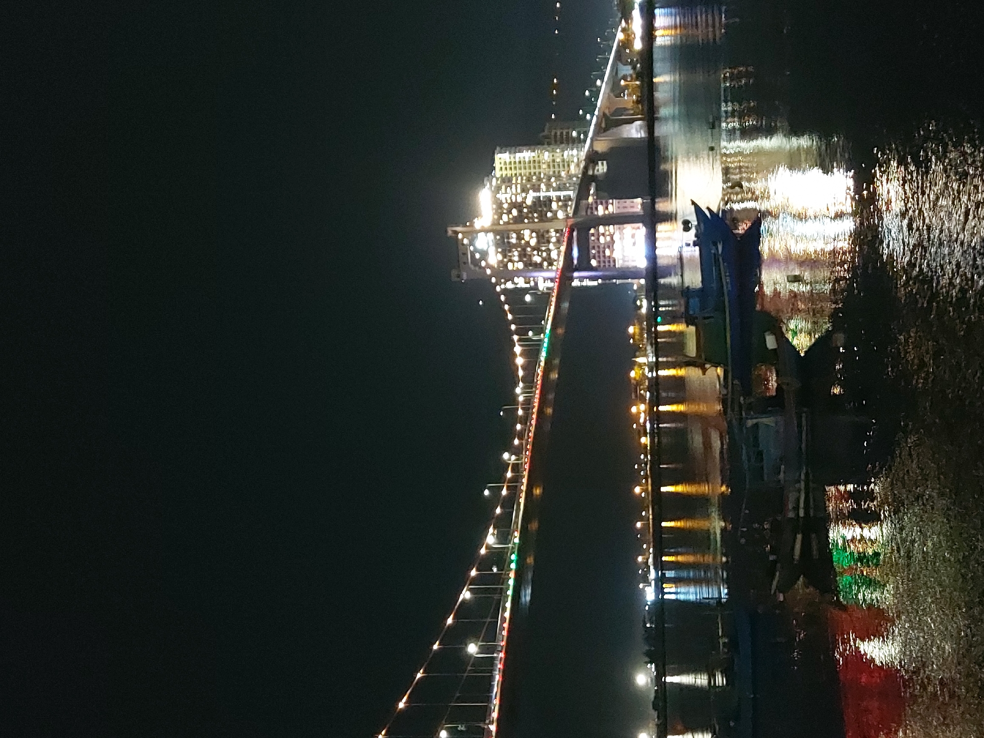 Da Nang's lit-up bridges reflecting across the Han River at night