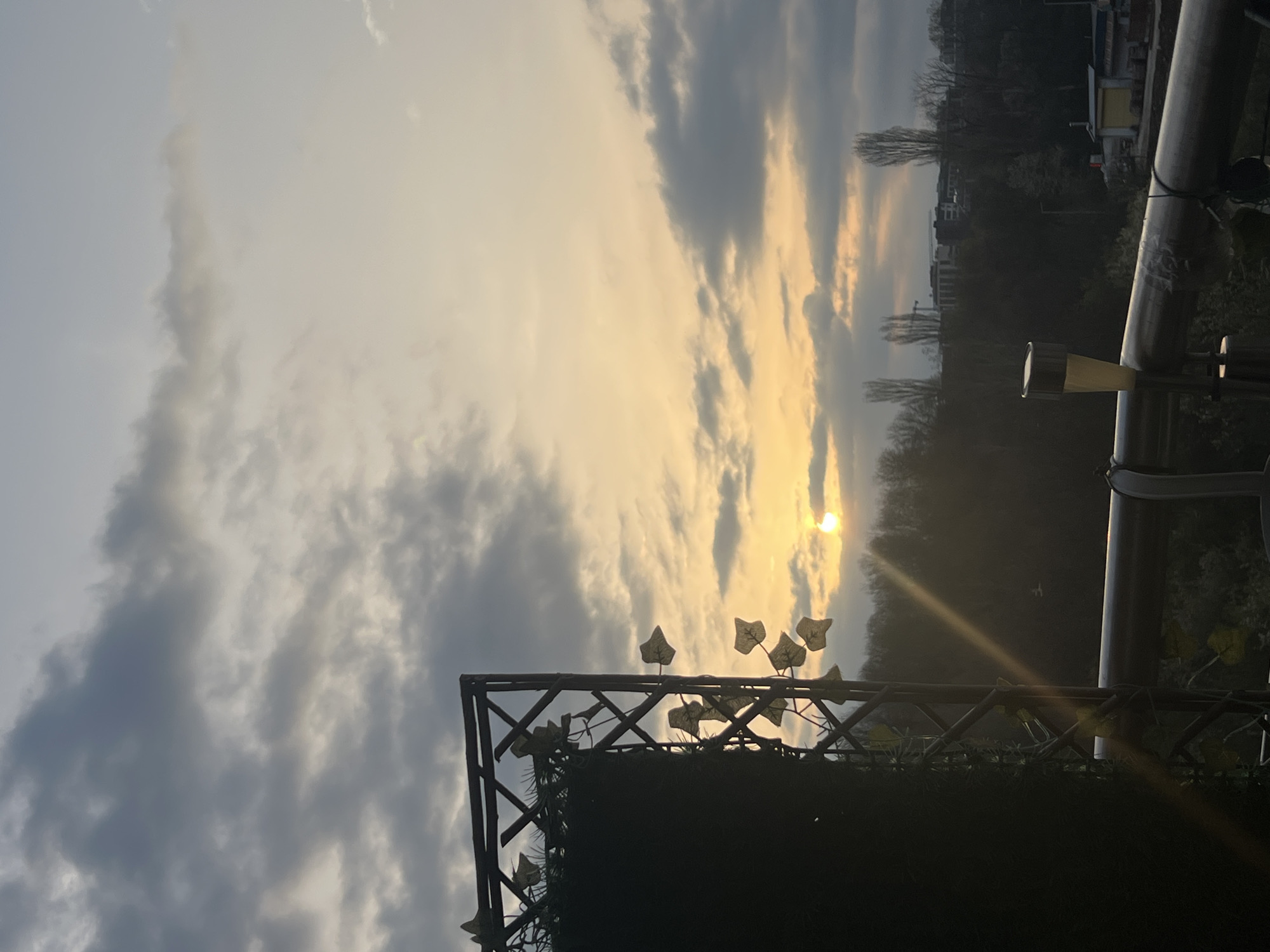 Evening sunset captured behind residential fence in Sofia, Bulgaria