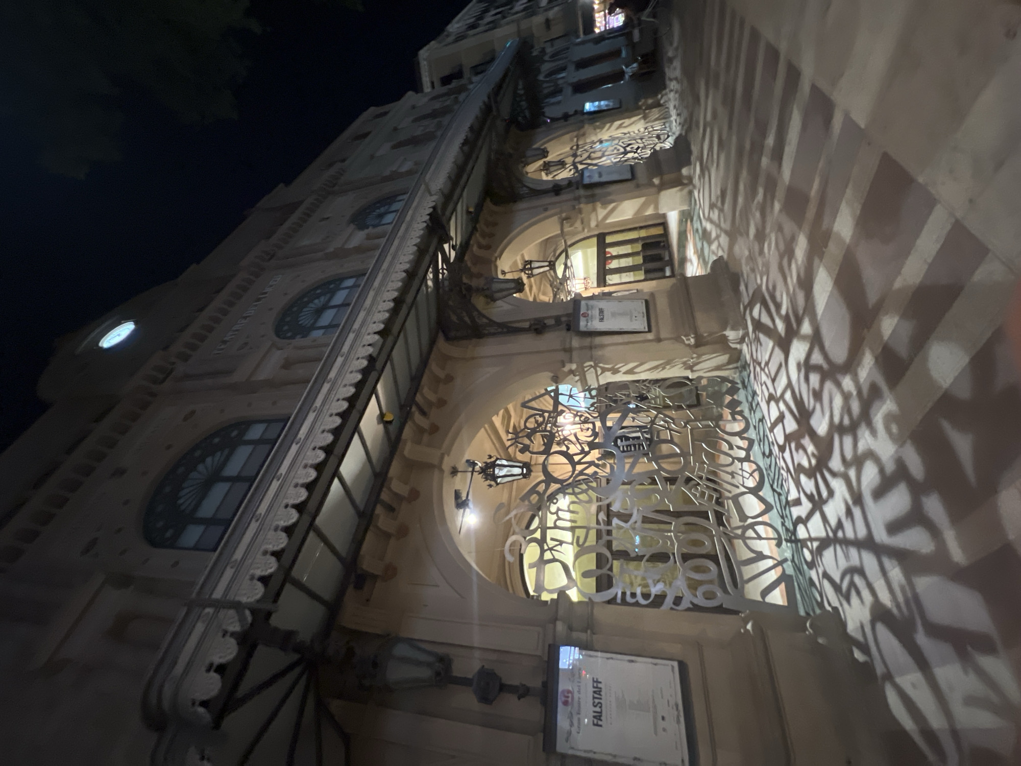 Abstract metal sculpture and classical architecture on a Barcelona night