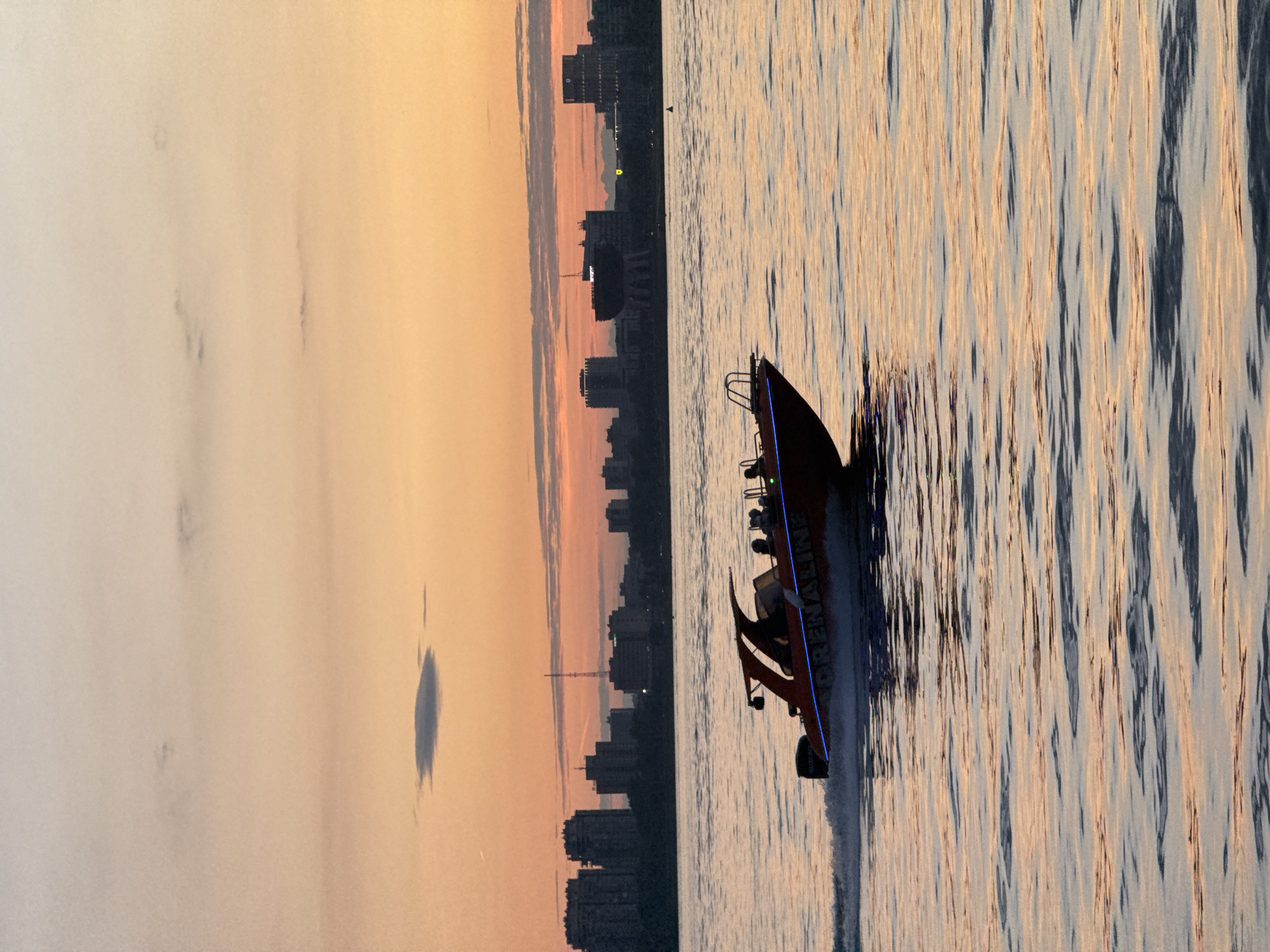 Speedboat cuts through Kazan's river at golden hour