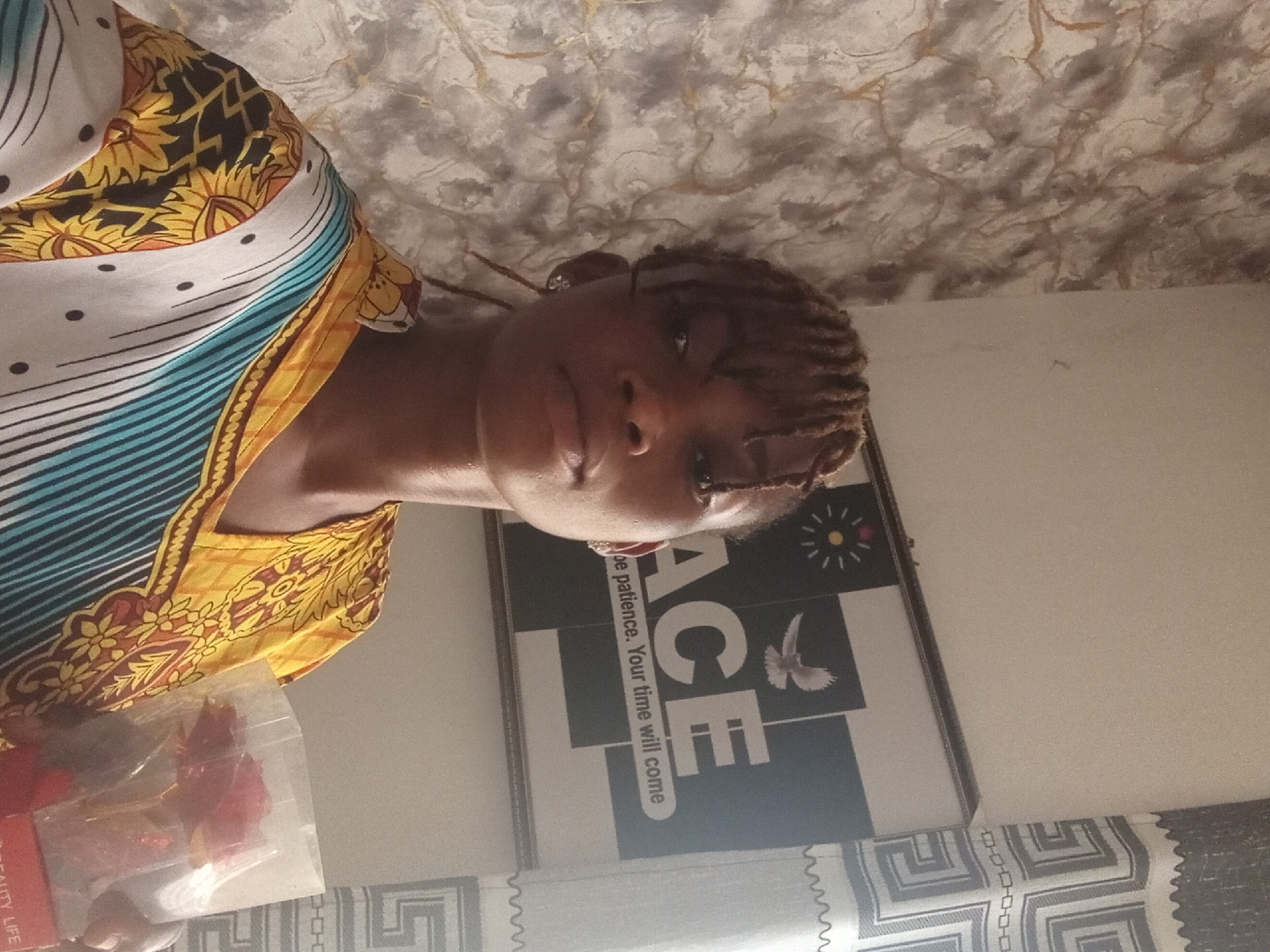 Woman with braided hair poses with roses in indoor setting