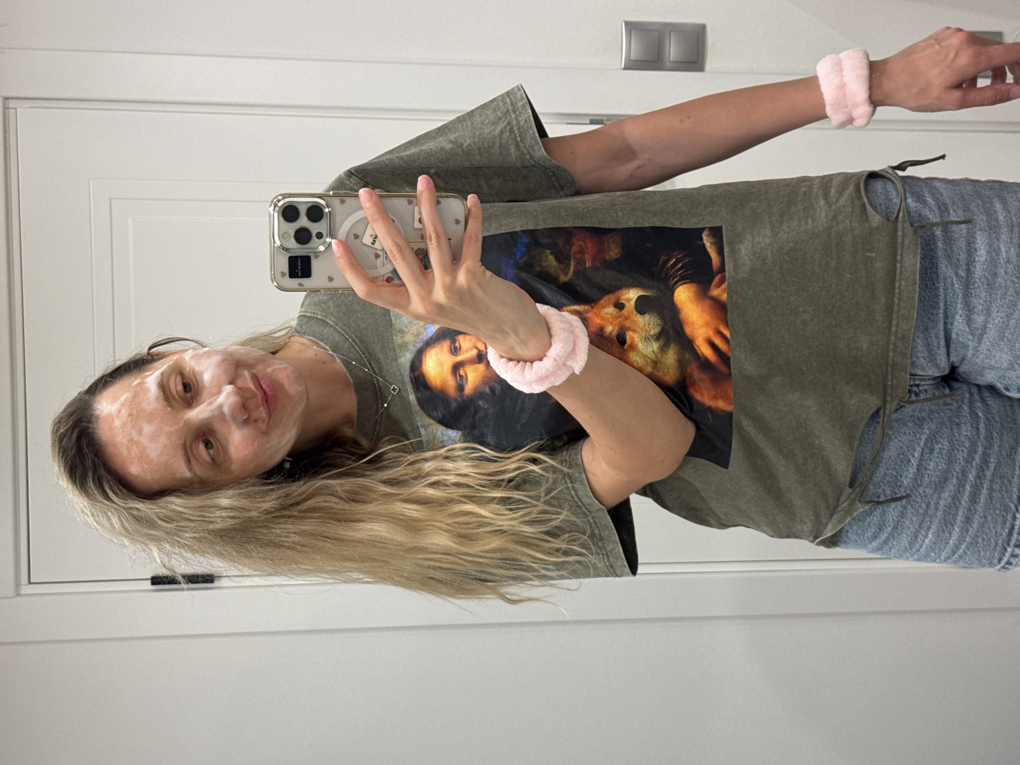 Woman takes masked selfie during skincare routine in Latvia