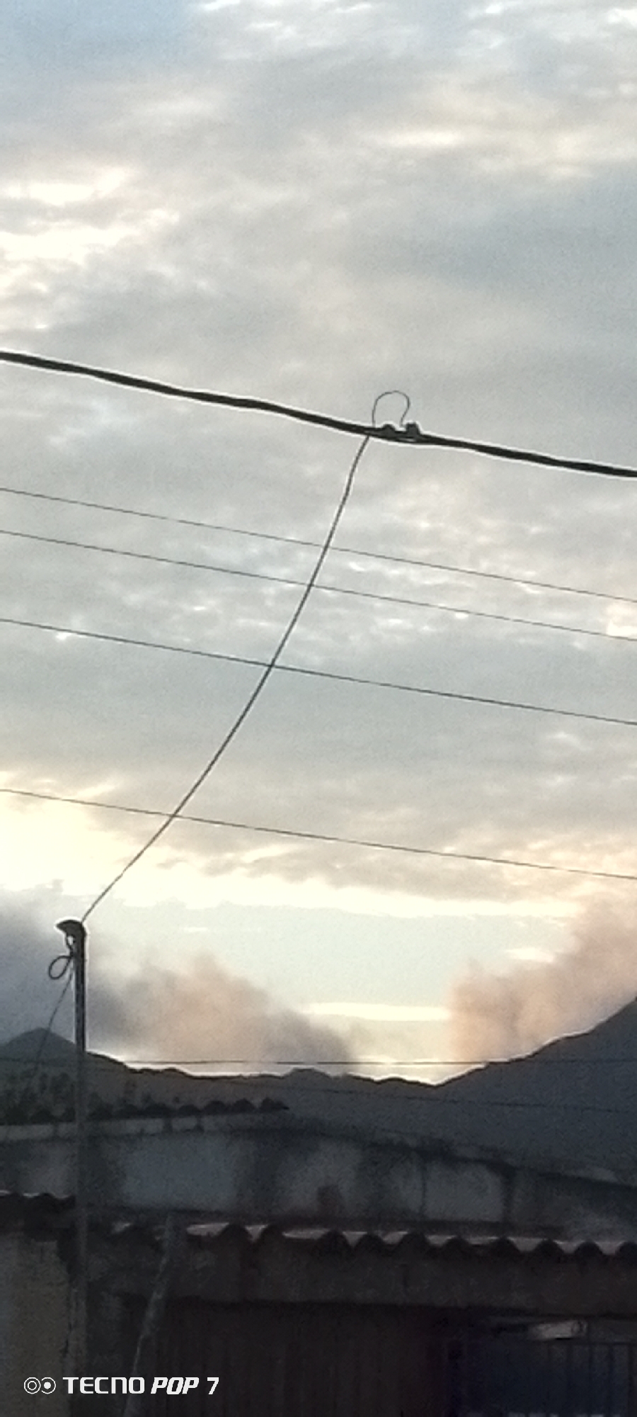 Skies over Altagracia, framed by trees and power lines