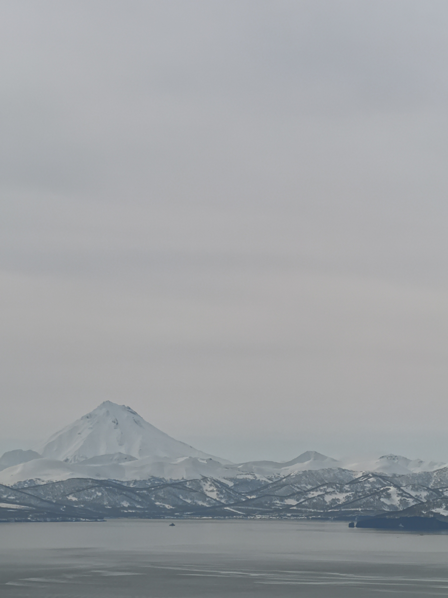 Snow-capped mountain landscape photographed with water foreground