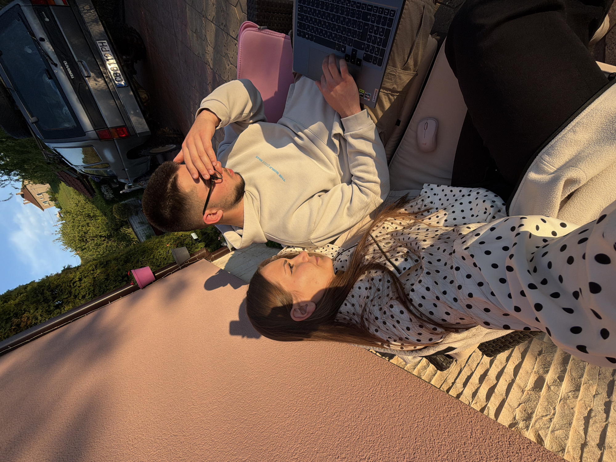 Couple enjoys leisurely afternoon with laptop on Bulgarian patio