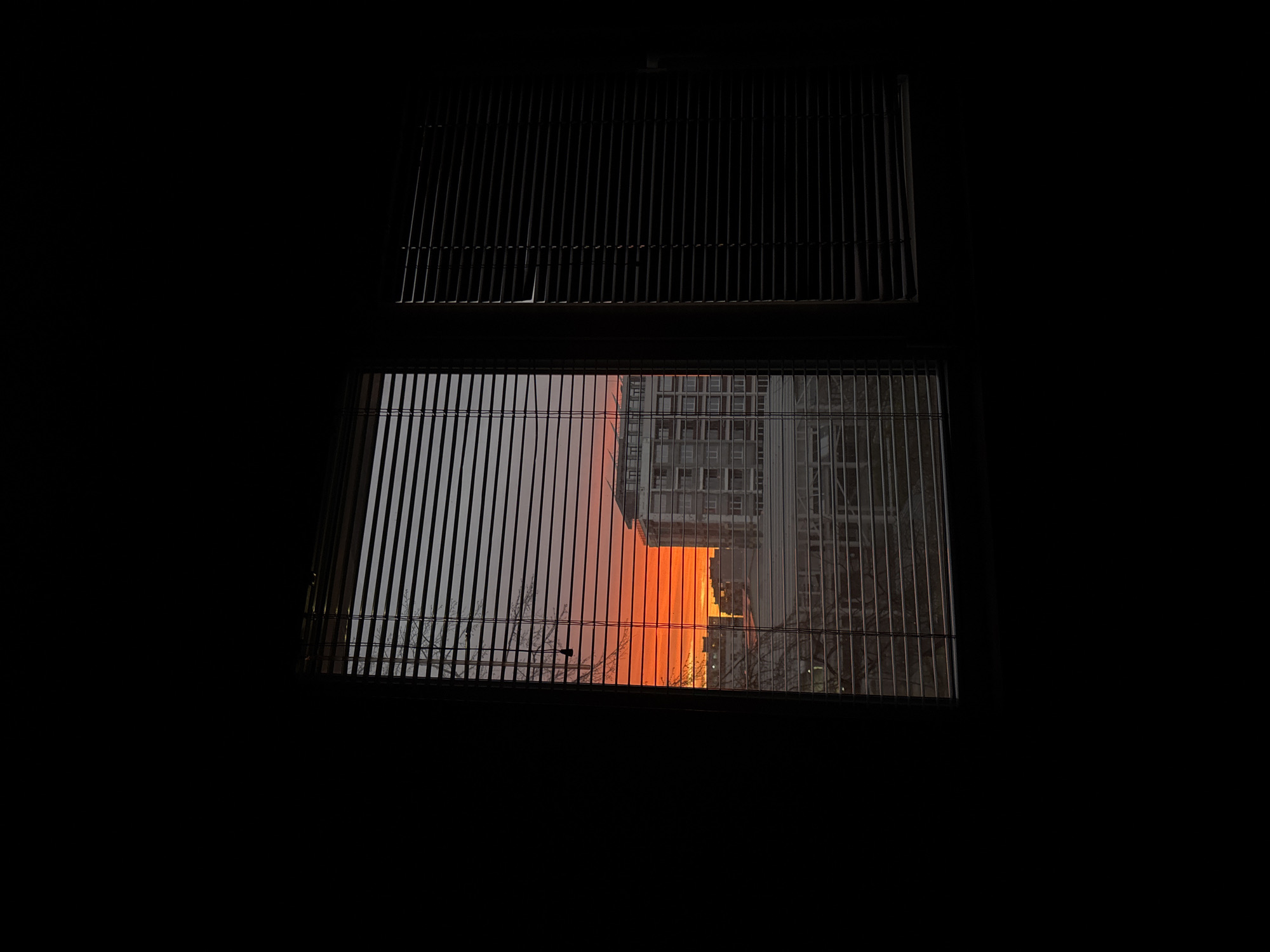 Sunset viewed through barred window in Ruse, Bulgaria