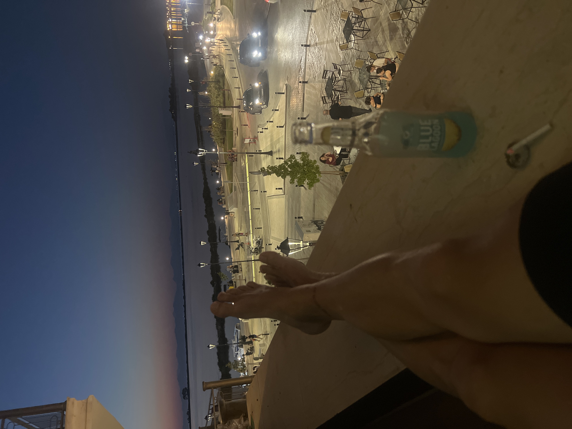 Feet up on a Lefkada balcony as dusk hits the harbor